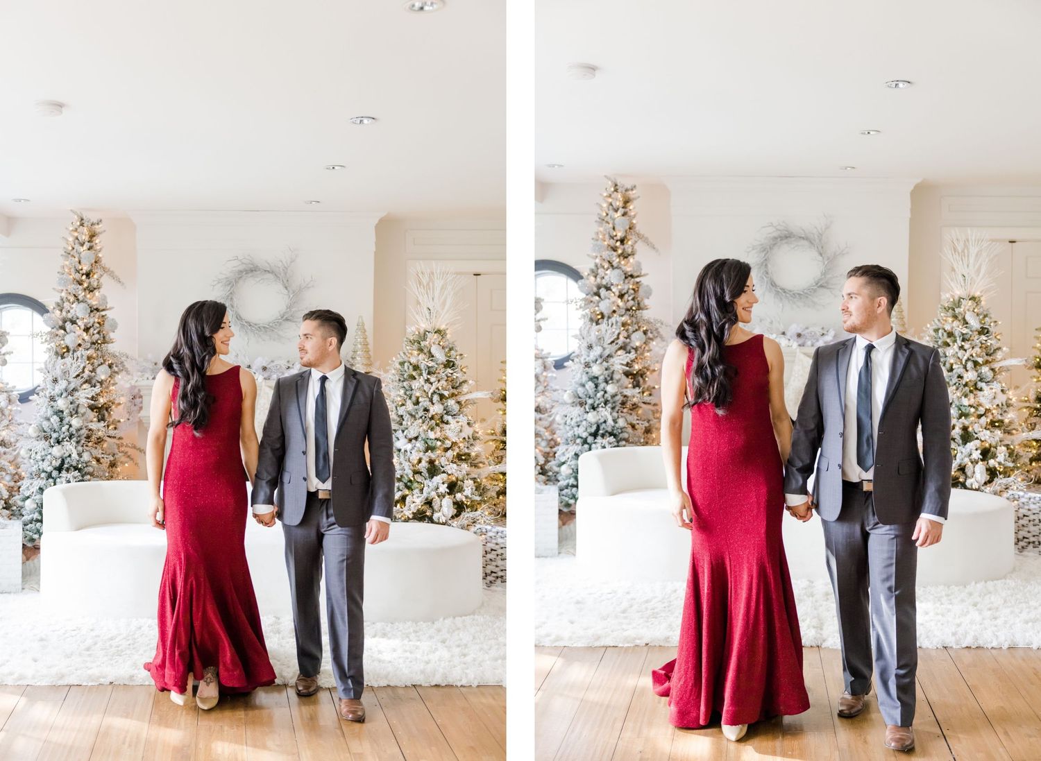 Elegant couple in formal wear stands between decorated white Christmas trees.