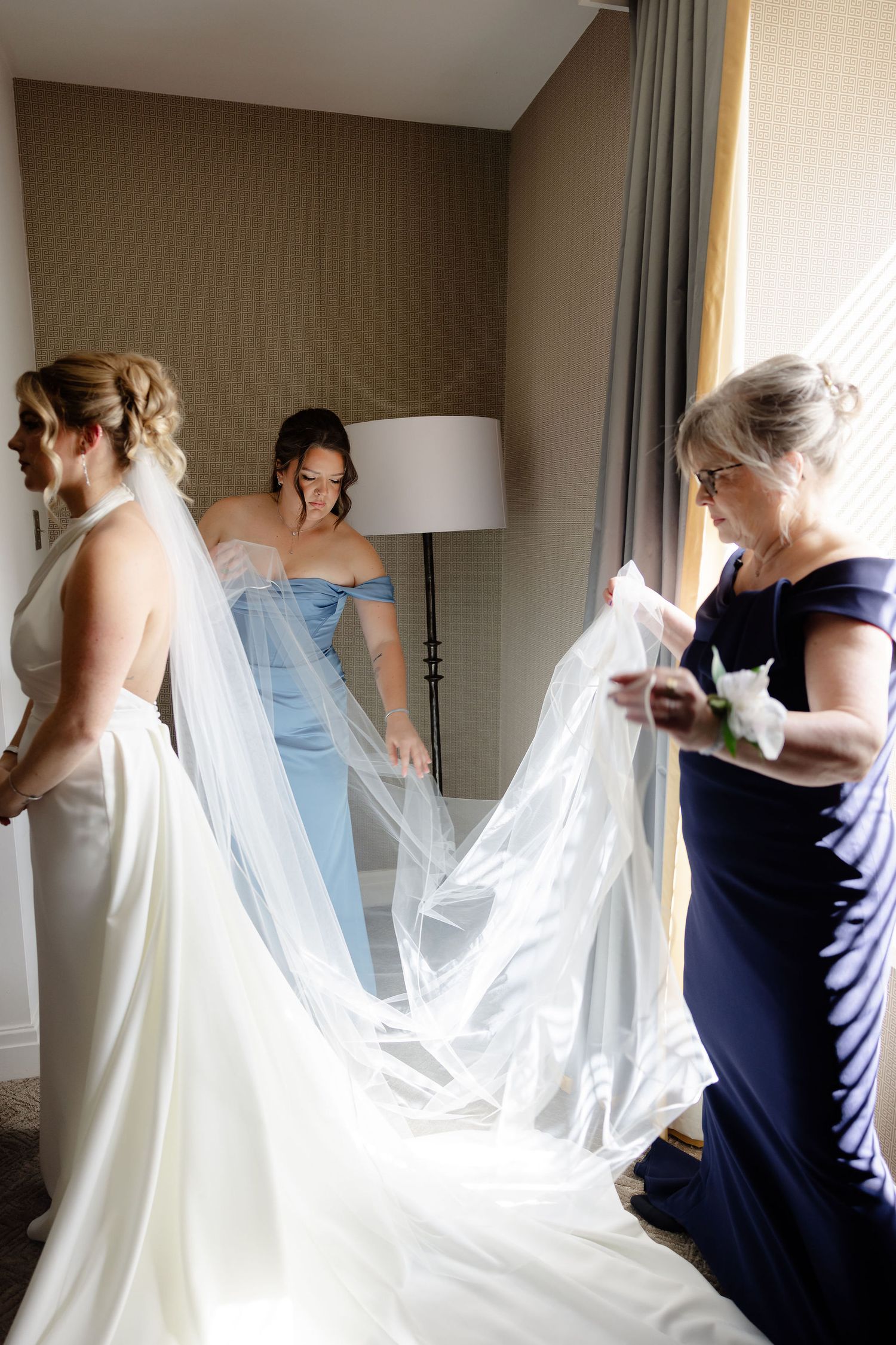 Sequence of wedding preparation shots showing the flowing movement of a white bridal veil against a neutral wall.