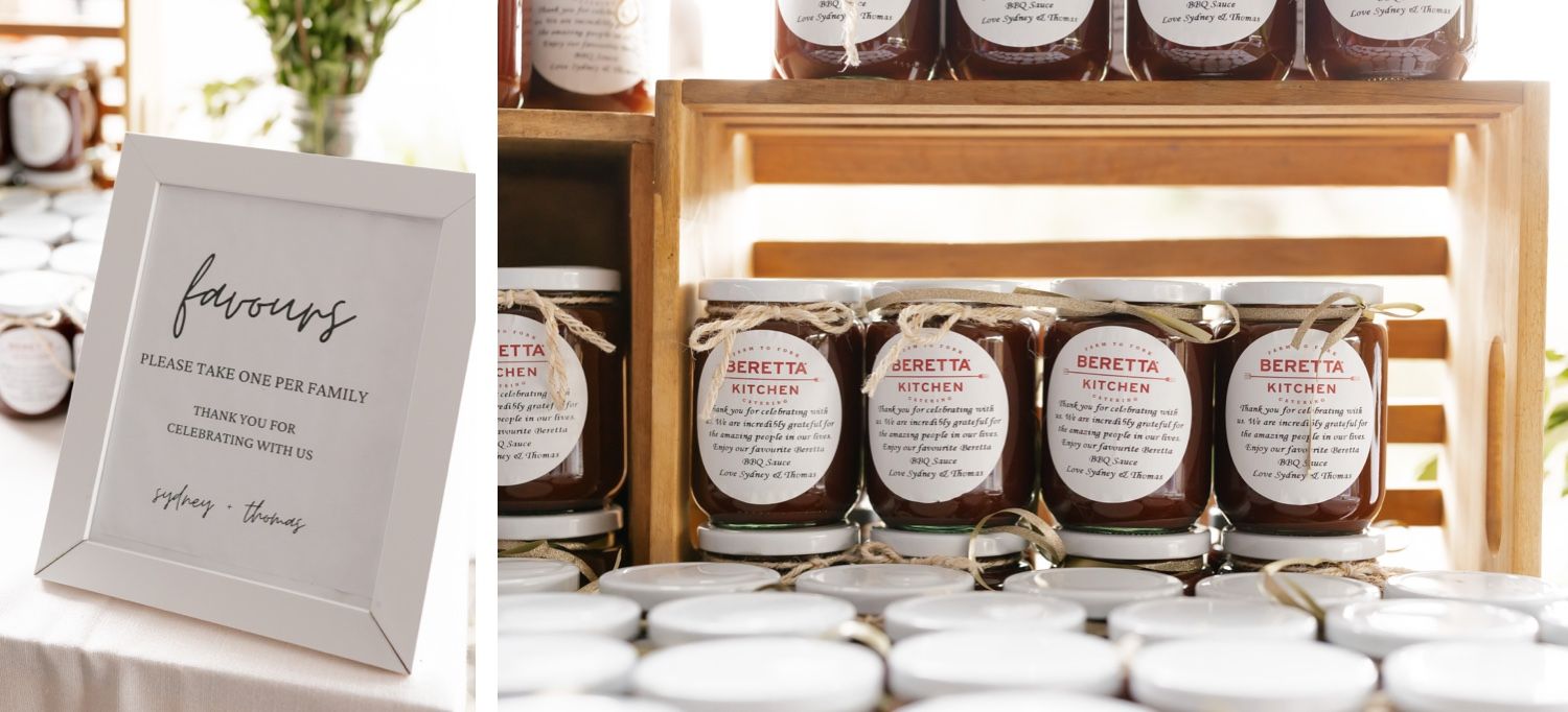 Wedding favors and signage displayed in wooden crates at rustic reception.