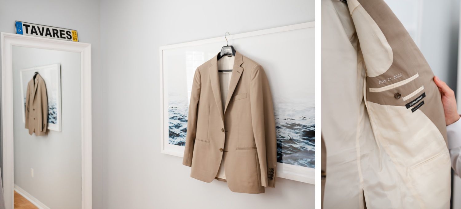 Beige suit jacket hanging in room with ocean artwork and minimal decor.
