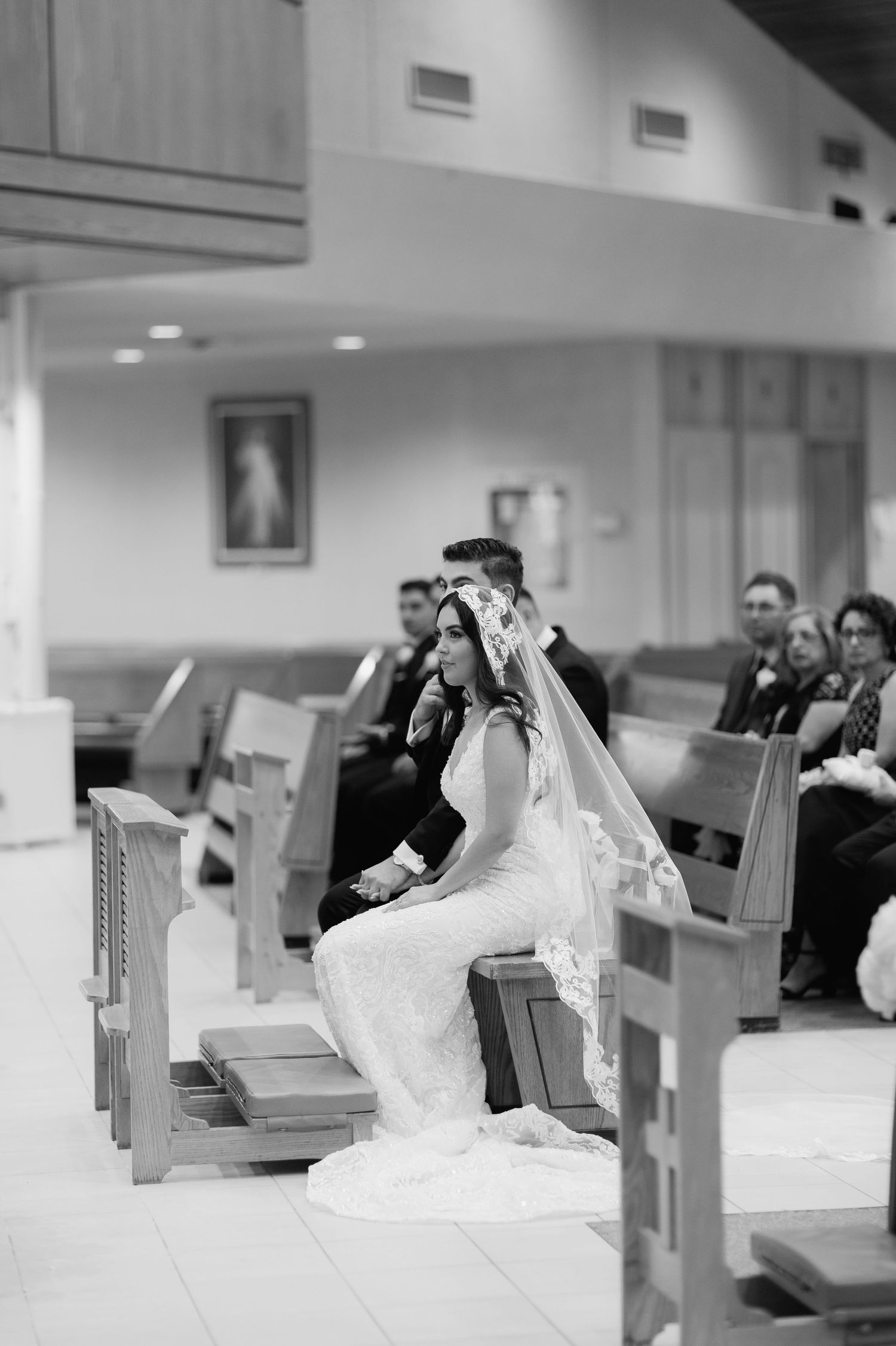 Black and white photo of a wedding ceremony in a modern church setting.