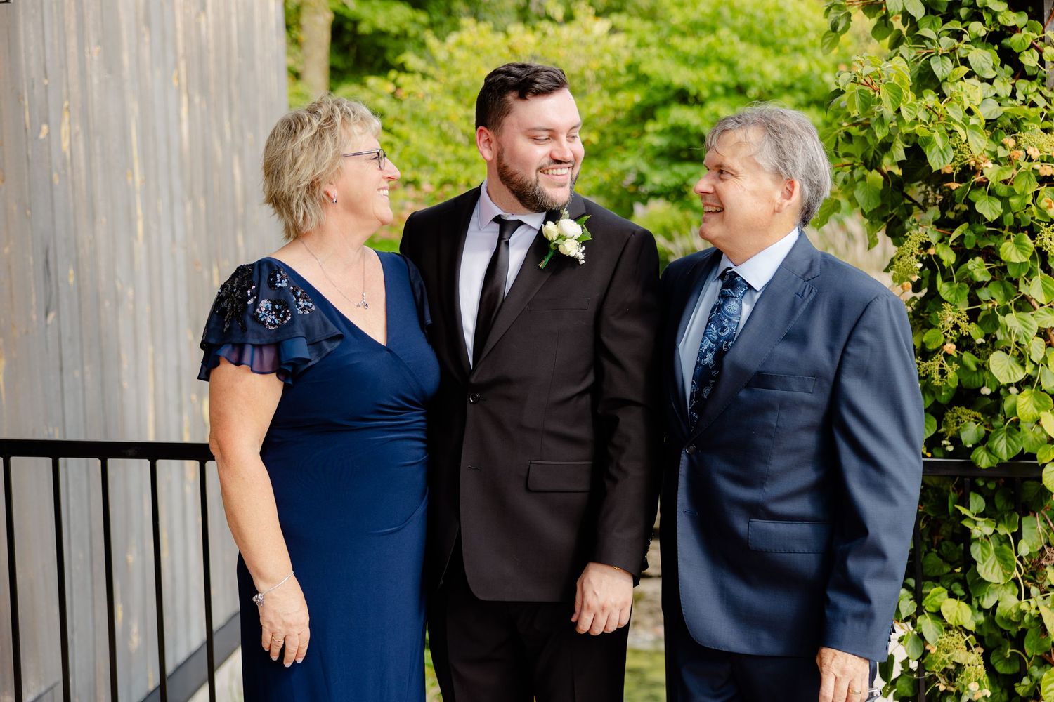 Candid moment of family laughing together at outdoor celebration.