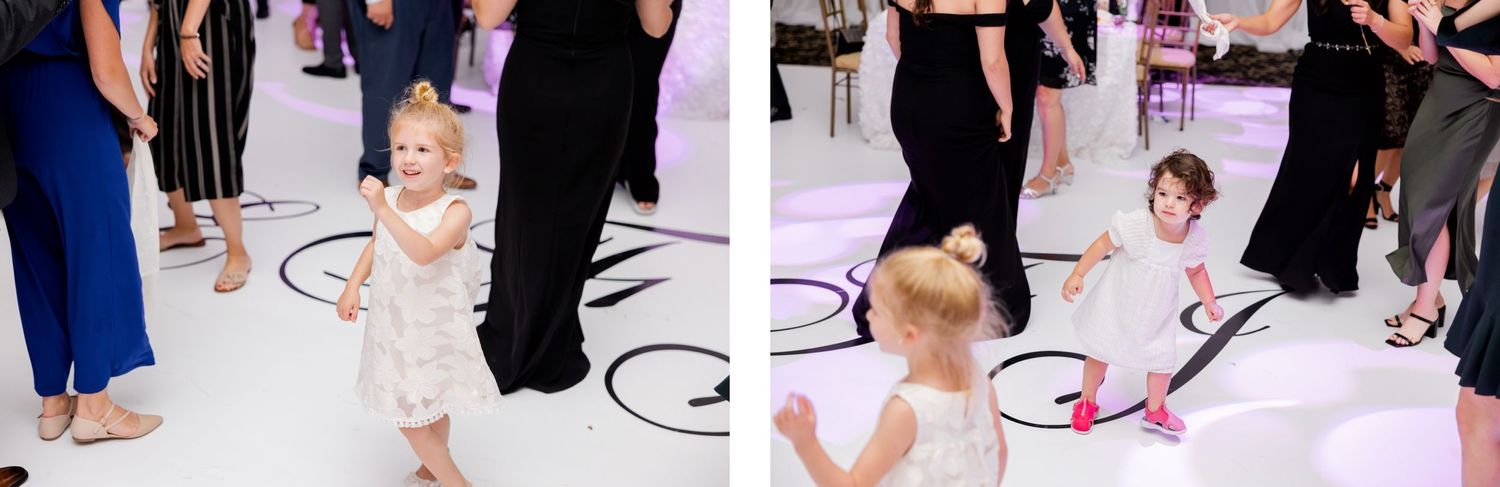 Children playing and dancing on a patterned dance floor at an elegant wedding reception.