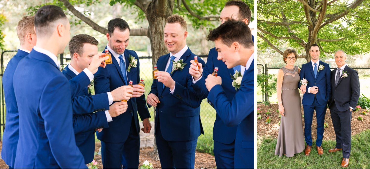 Groomsmen in matching navy suits share celebratory drinks outdoors.