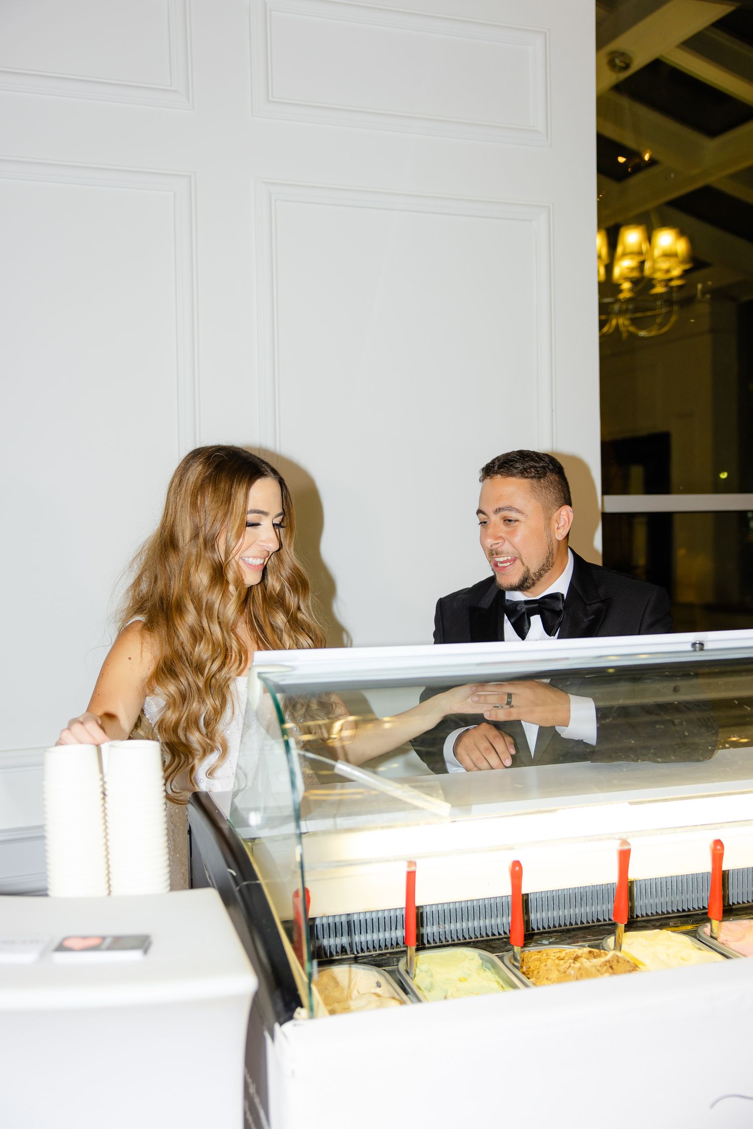Couple looking at ice cream selections at their wedding reception.