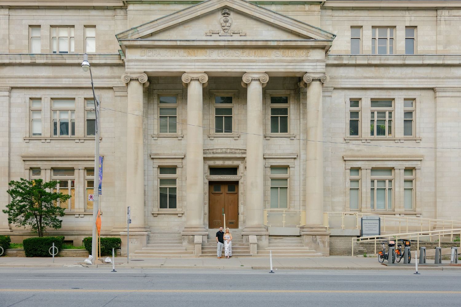 A grand neoclassical building facade with columns and stone steps leading to the entrance.