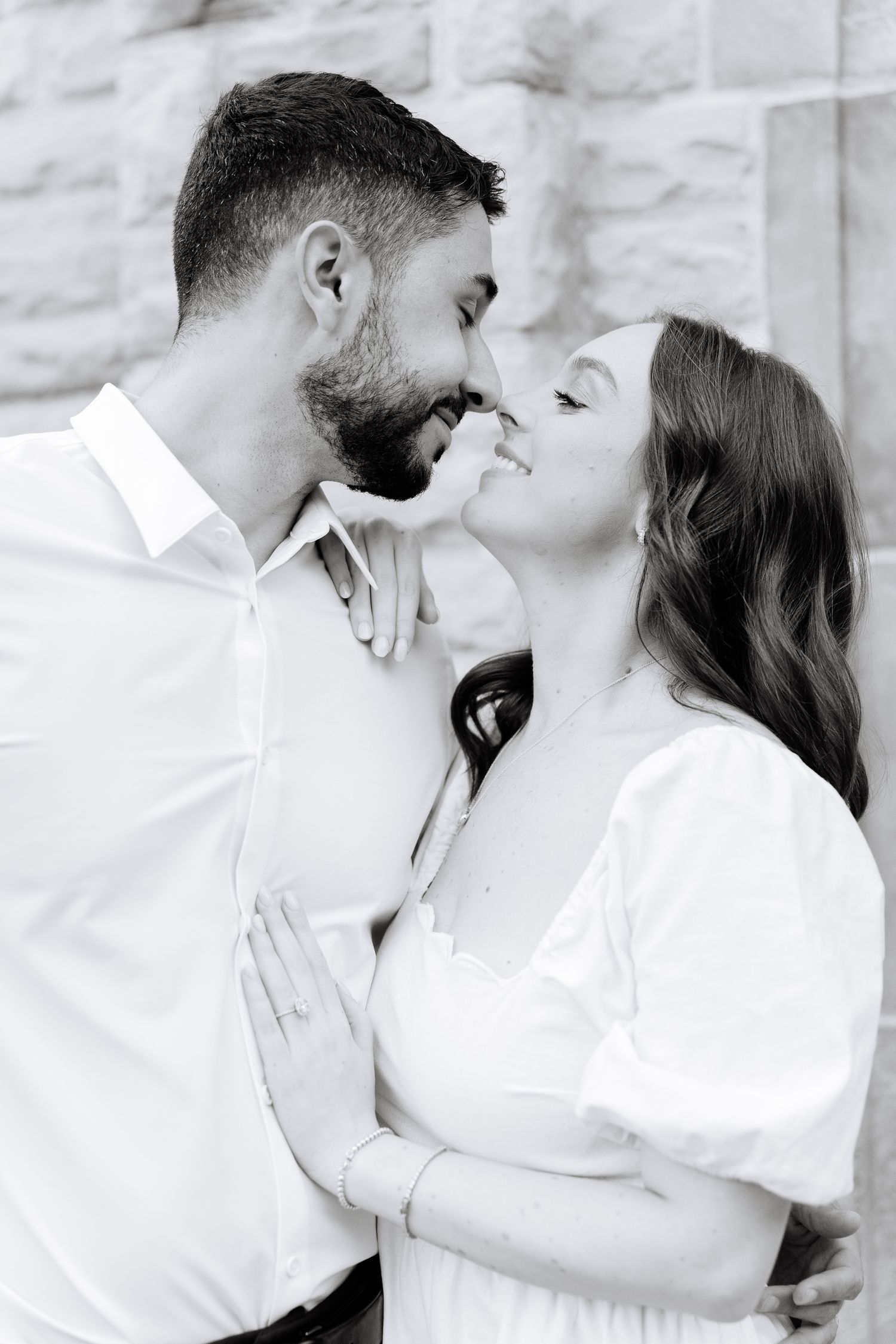 Intimate black and white portrait of couple sharing a romantic moment.