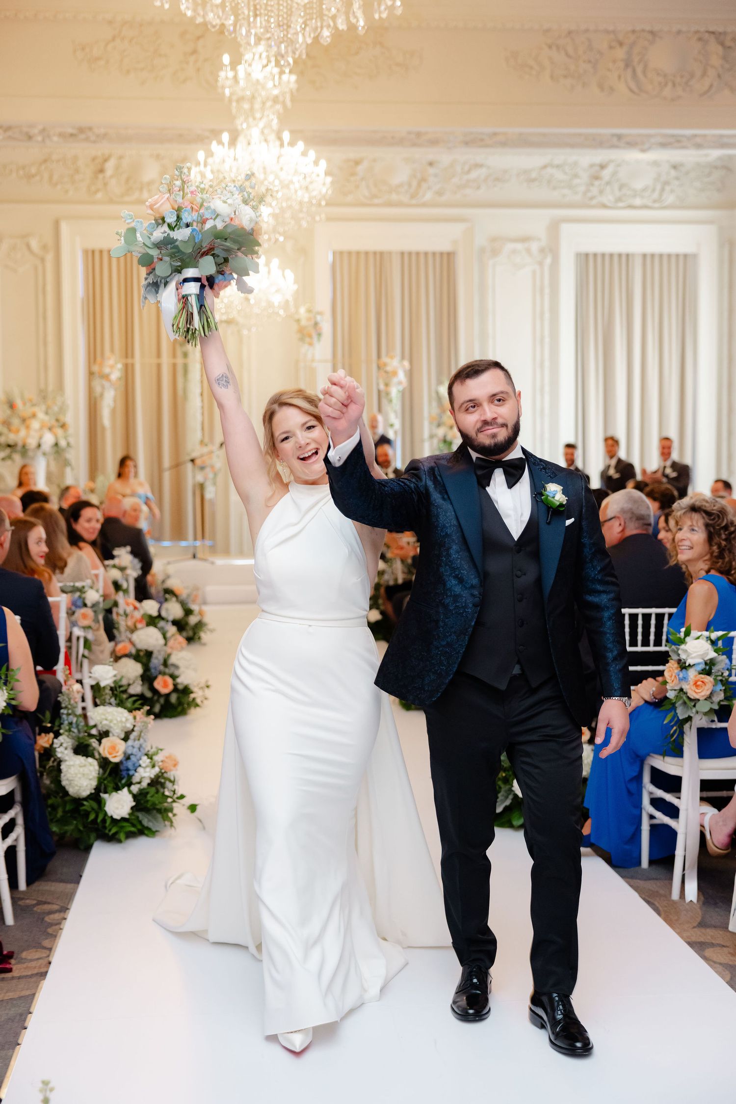 Wedding celebration sequence showing joyful moments in an elegant ballroom with crystal chandeliers and floral arrangements.
