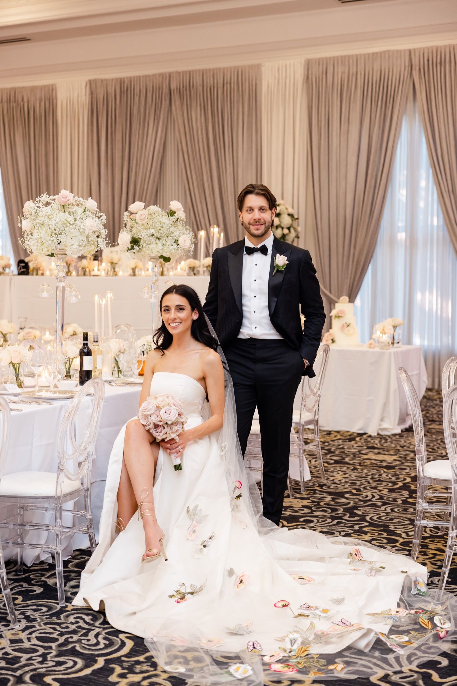 Wedding reception room with formal table settings.