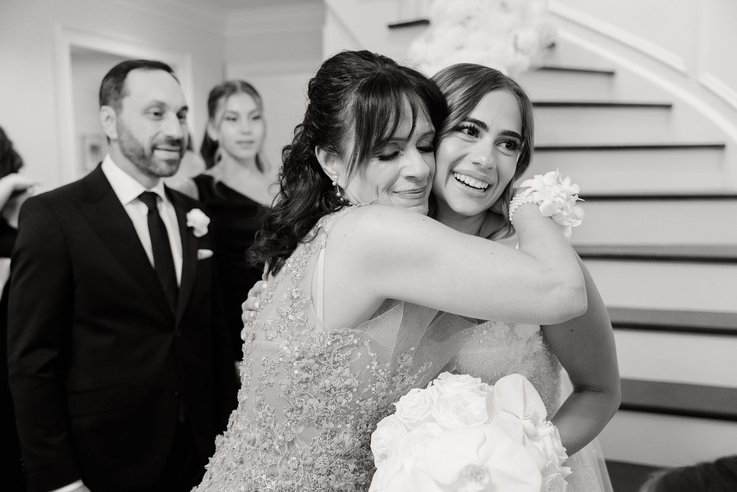 A series of black and white photos showing happy moments at a formal wedding celebration.