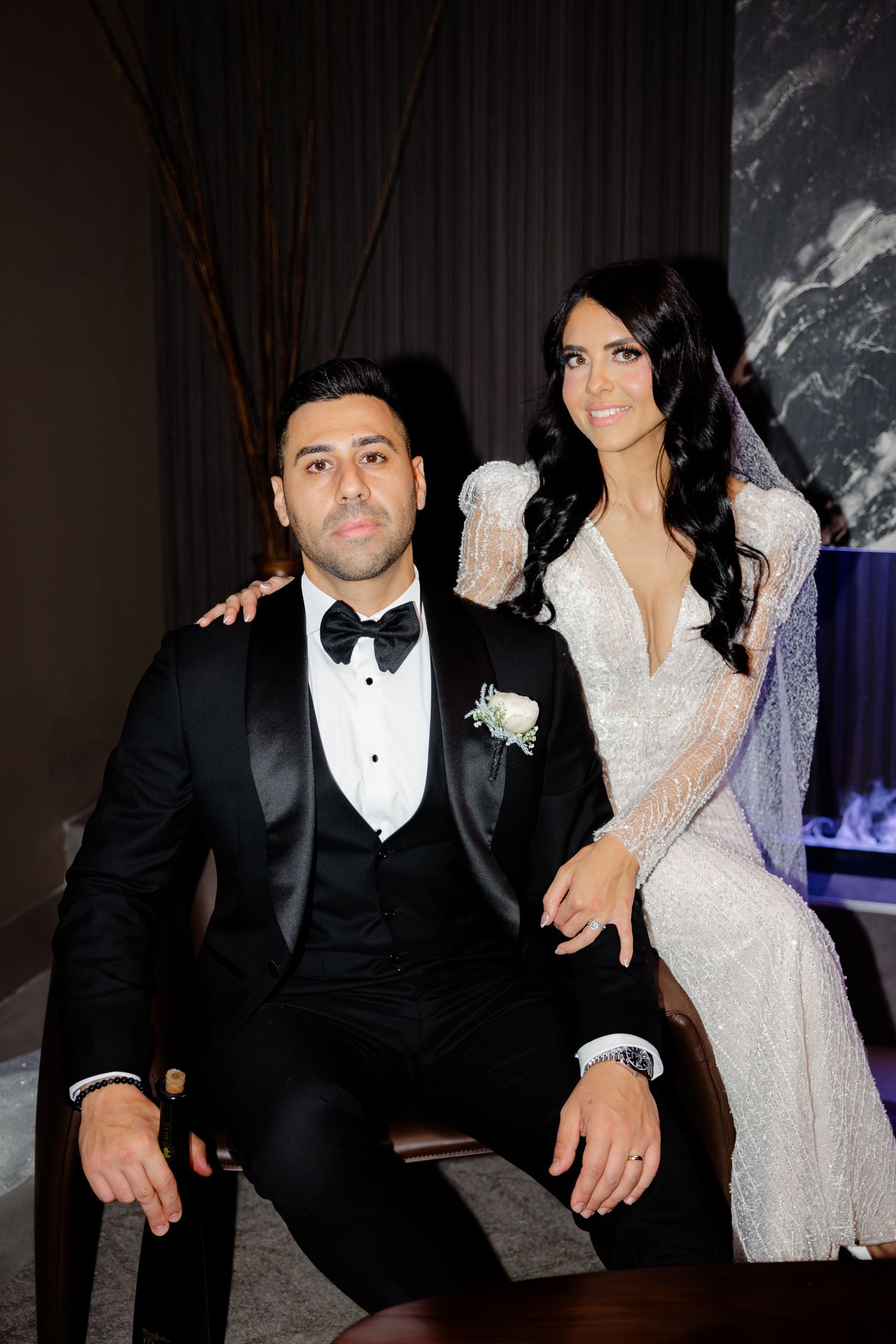 Wedding couple in elegant attire poses together during formal photo session.