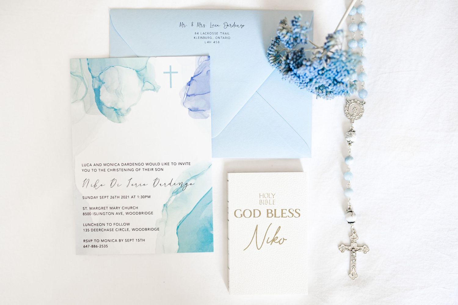 Baptism invitation suite in light blue watercolor design with rosary and religious accents.