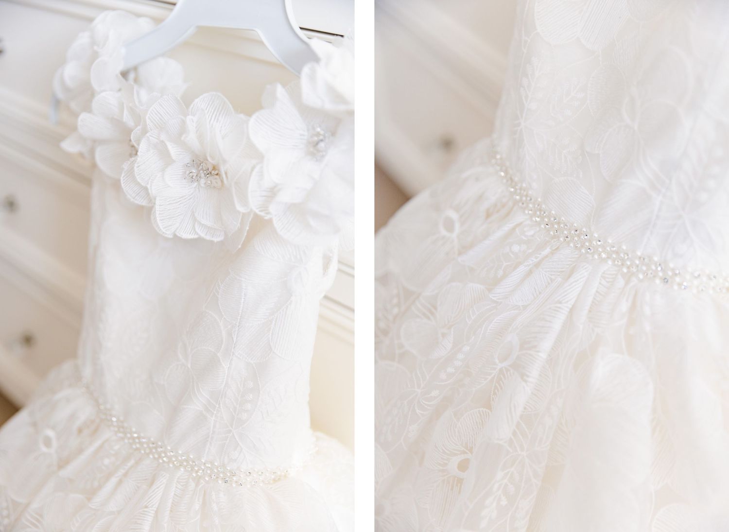 Close-up details of white wedding dress showing delicate floral appliques and beading.