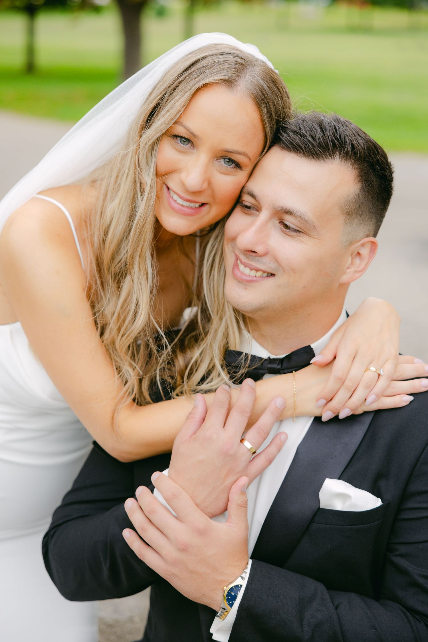 Wedding couple shares intimate moment during outdoor portrait session.