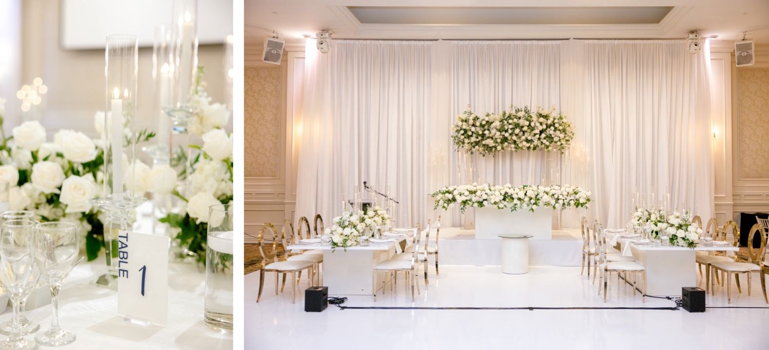 Modern white wedding reception space with elegant drapery and suspended floral installations.