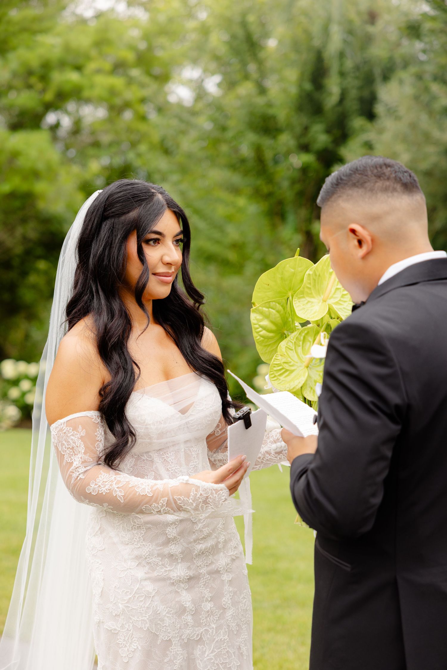 Wedding couple shares intimate first look moment in outdoor garden setting, captured in beautiful sequence of photos.