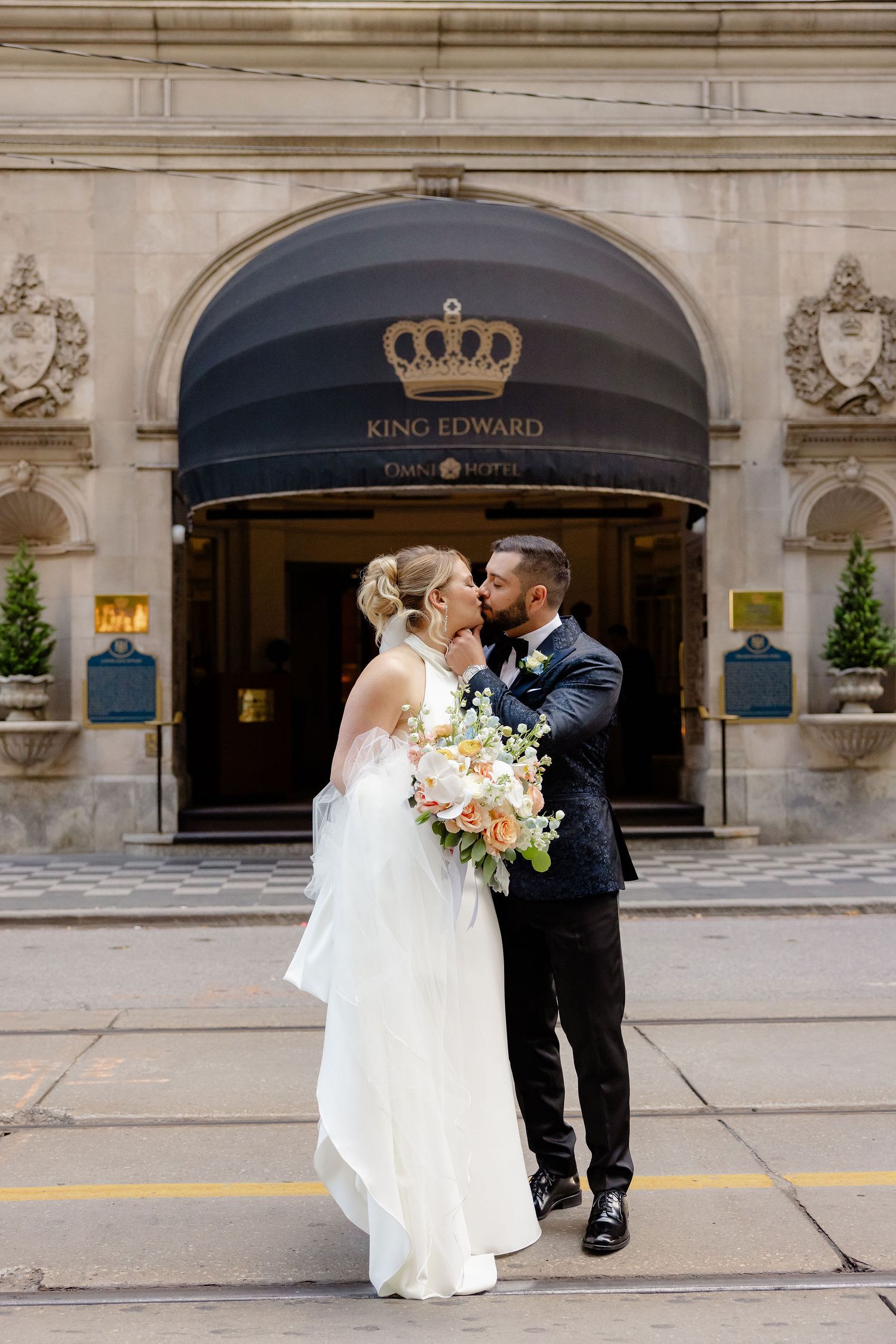 Newlyweds pose for romantic photos in front of the King Edward Hotel's iconic entrance.