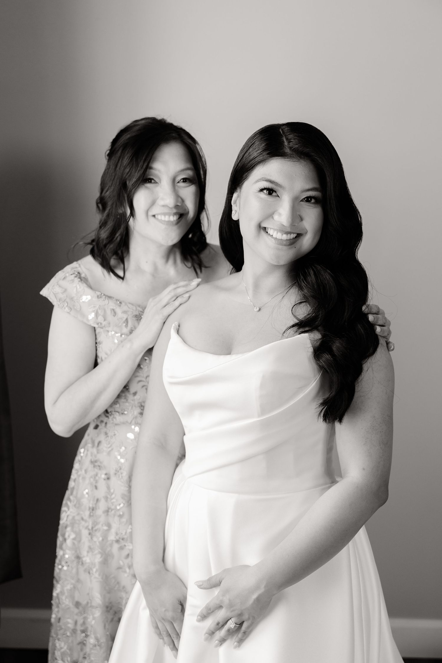 A classic black and white portrait showcasing genuine smiles and elegant wedding attire.