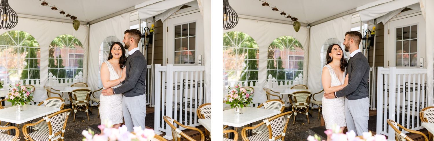 A couple embraces on a covered porch in black and white.