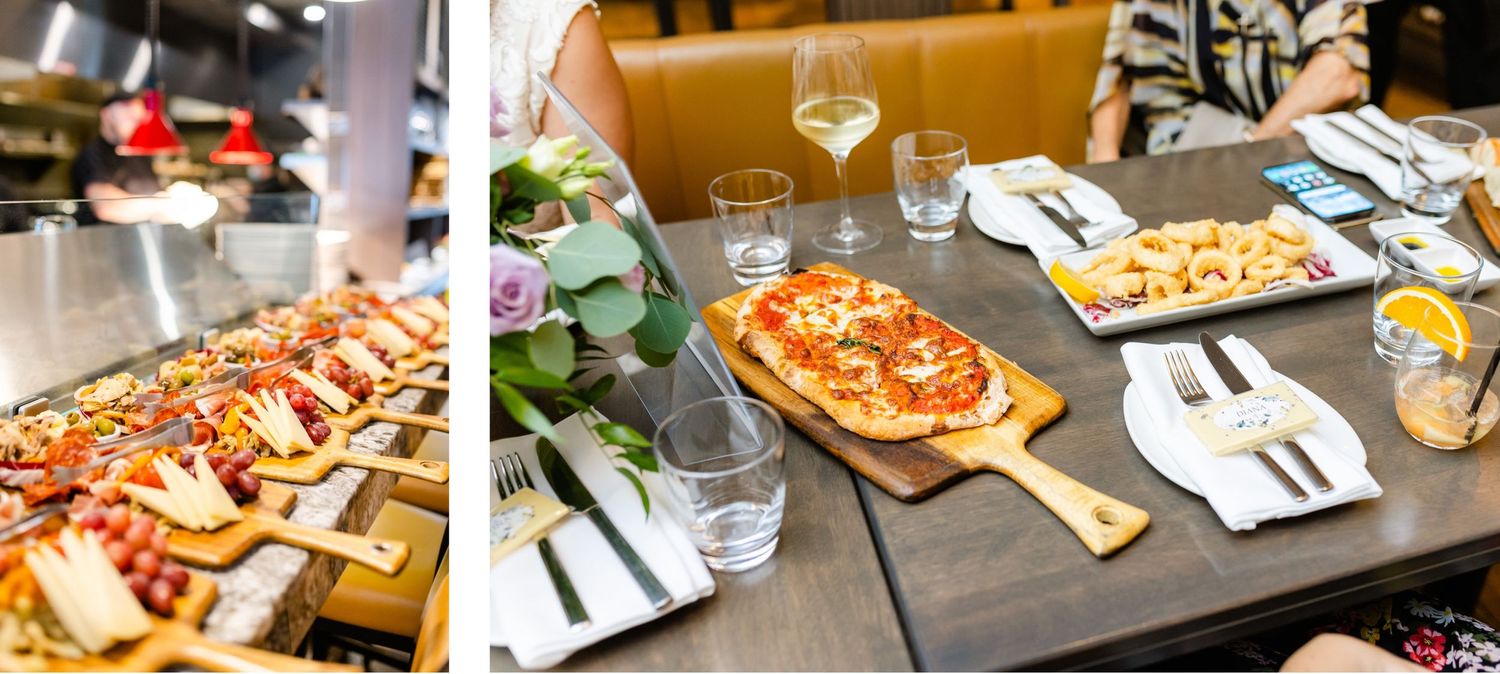 Flatbread pizzas and appetizers arranged on wooden tables at an upscale dining event.