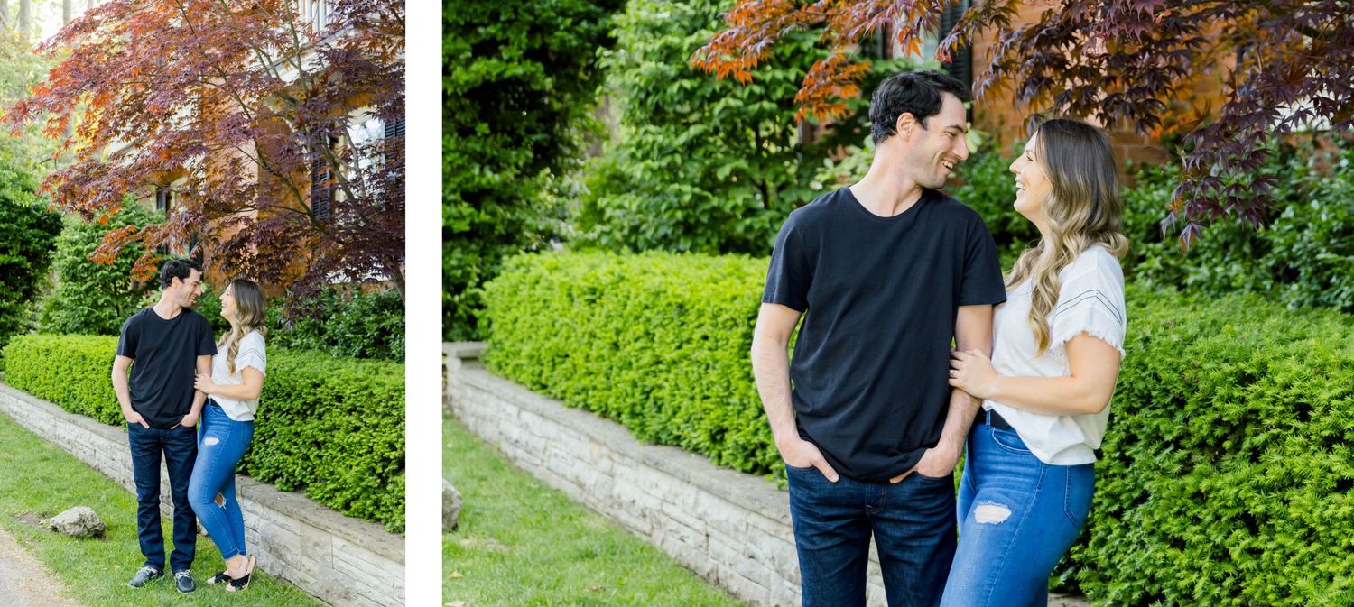 Two candid photos of a couple posing in front of manicured hedges and trees in a garden setting.