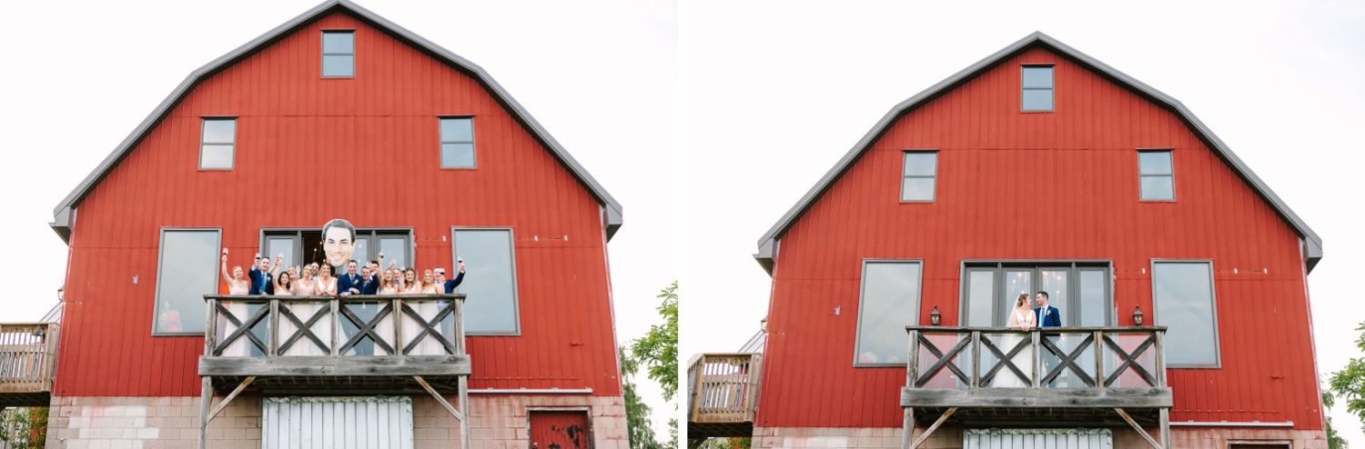 A bright red barn with white trim features a rustic balcony and classic farmhouse architecture.