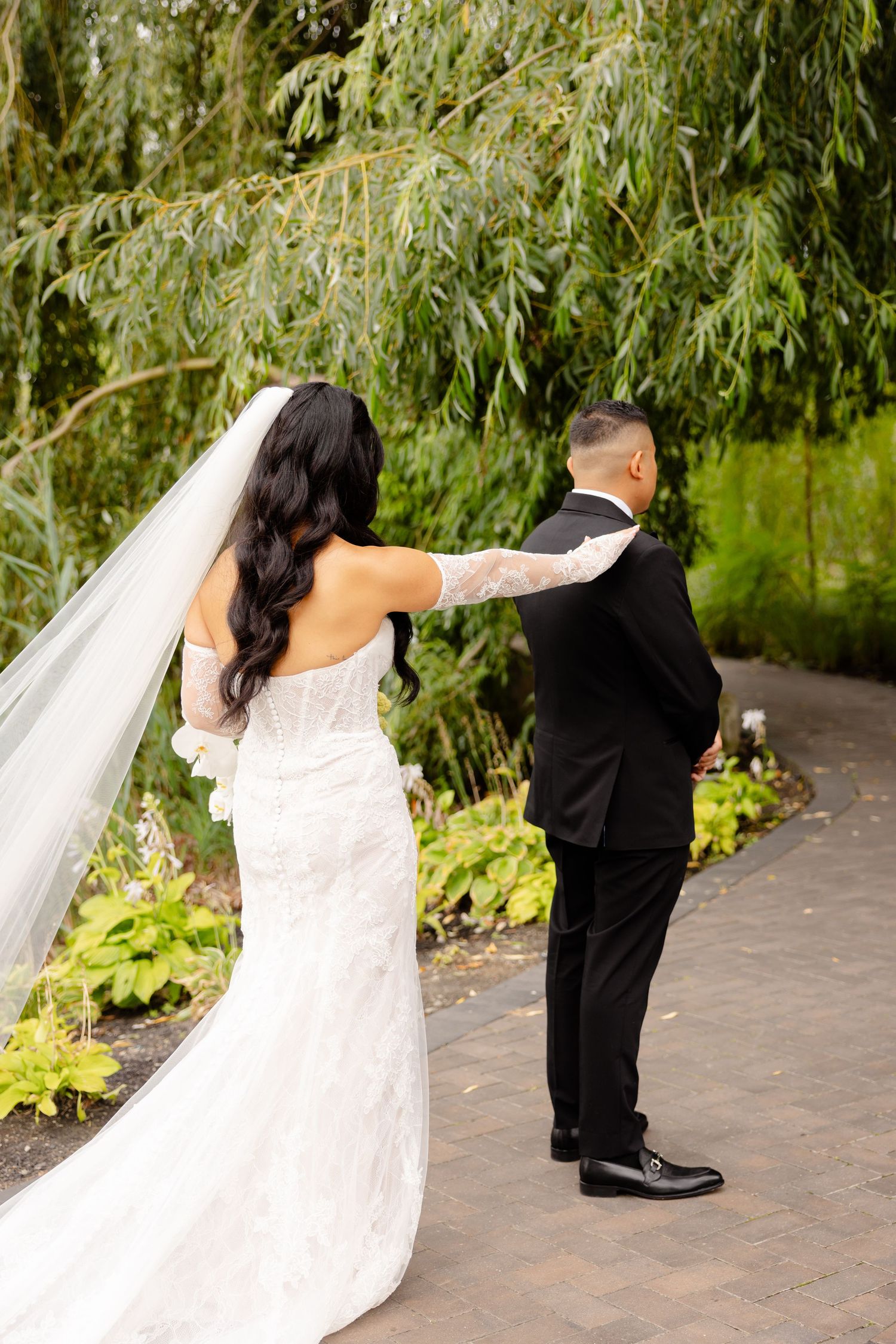 A sequence of wedding dance poses showing a dip move between two people in formal attire on a brick pathway.