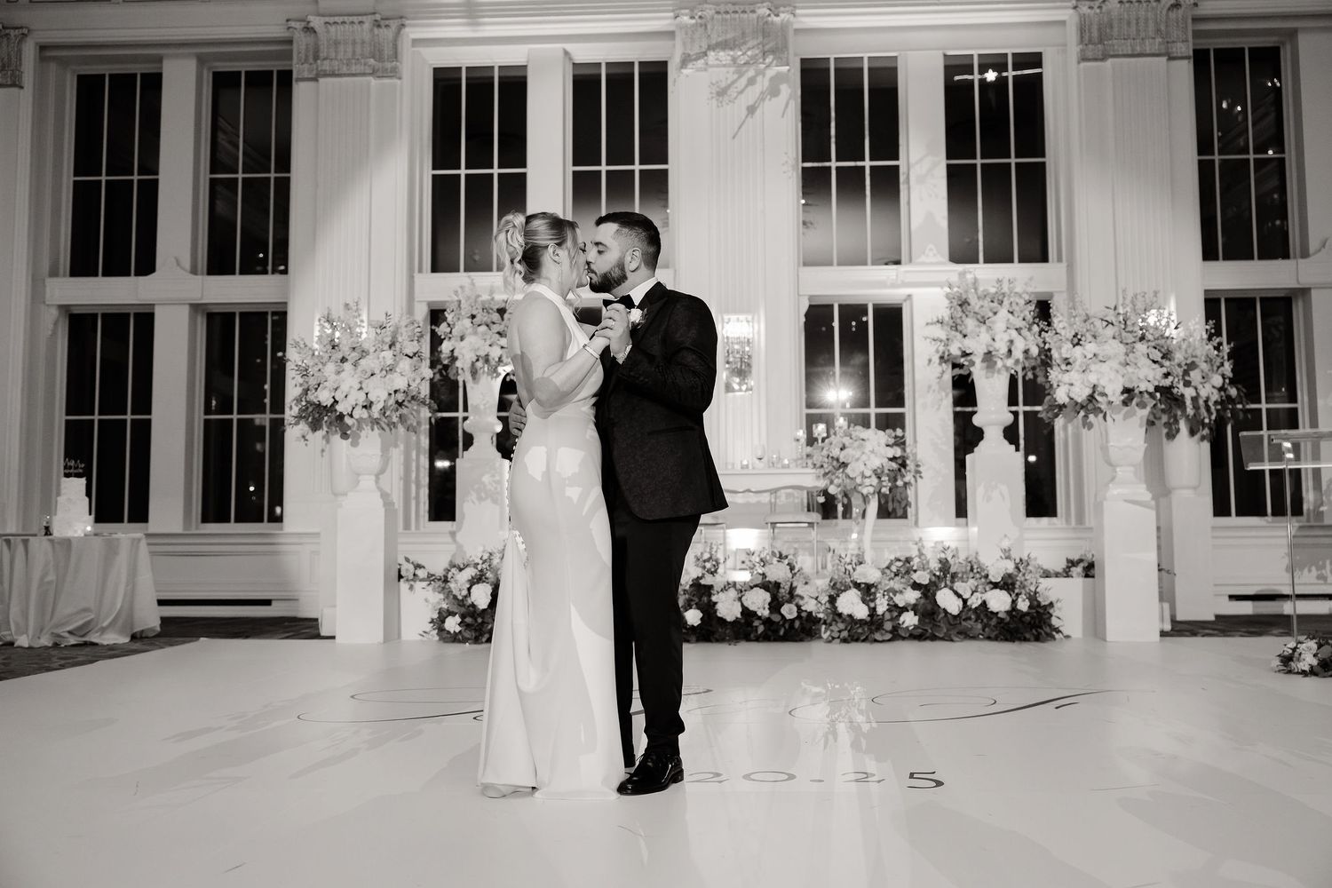 Black and white panoramic view of wedding reception venue with classic architectural details.