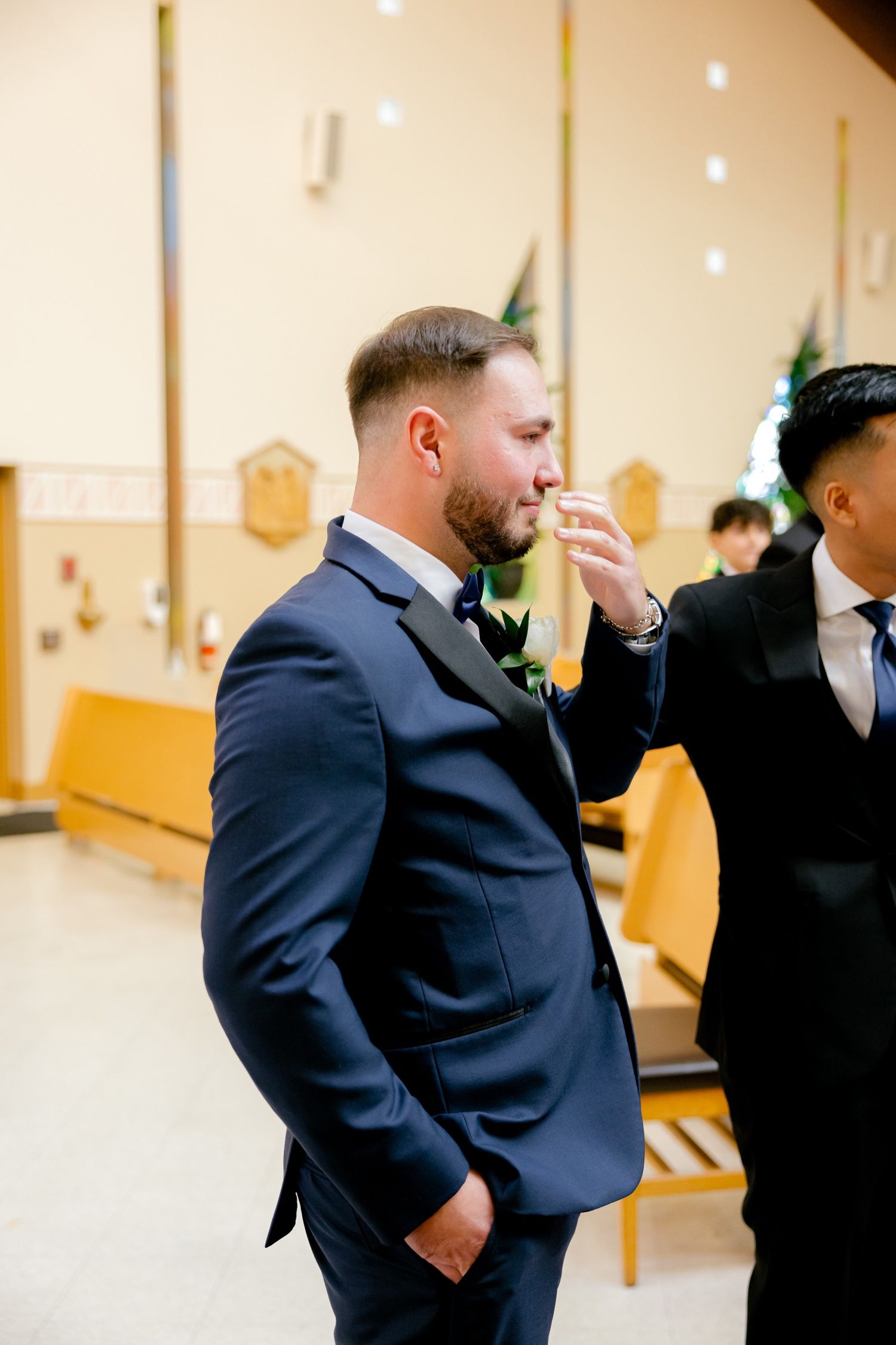Emotional moment captured during wedding ceremony in church setting.