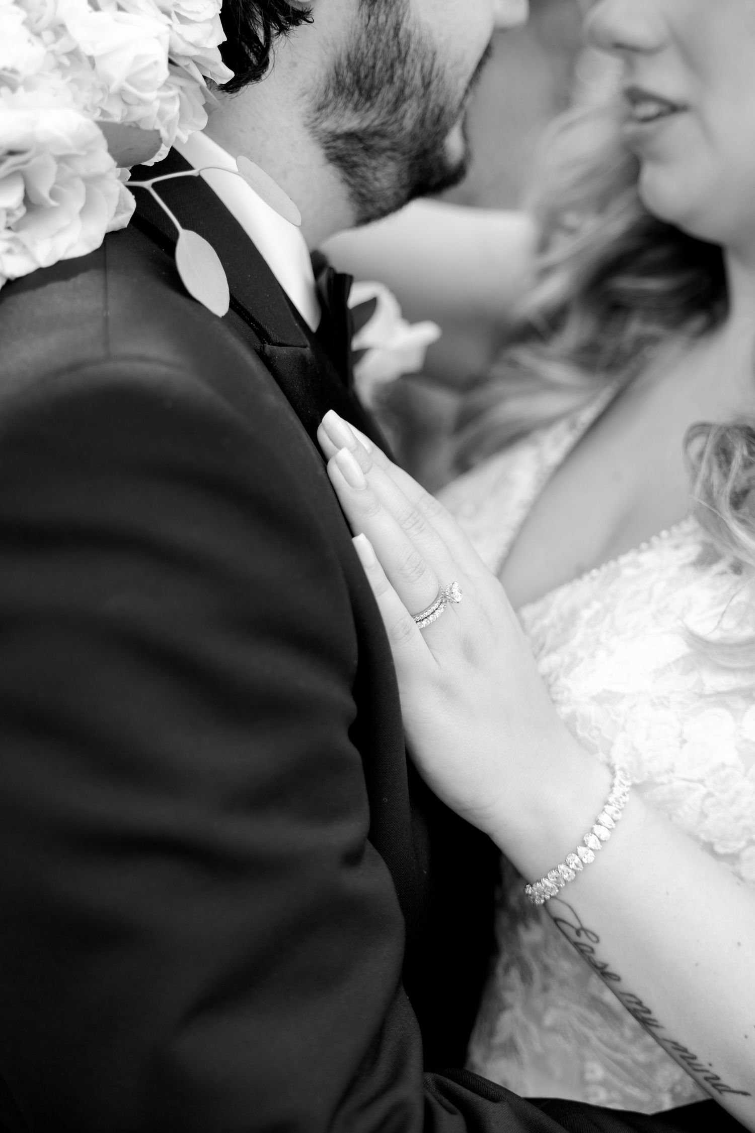 Black and white close-up showcasing wedding details with delicate lace and jewelry.