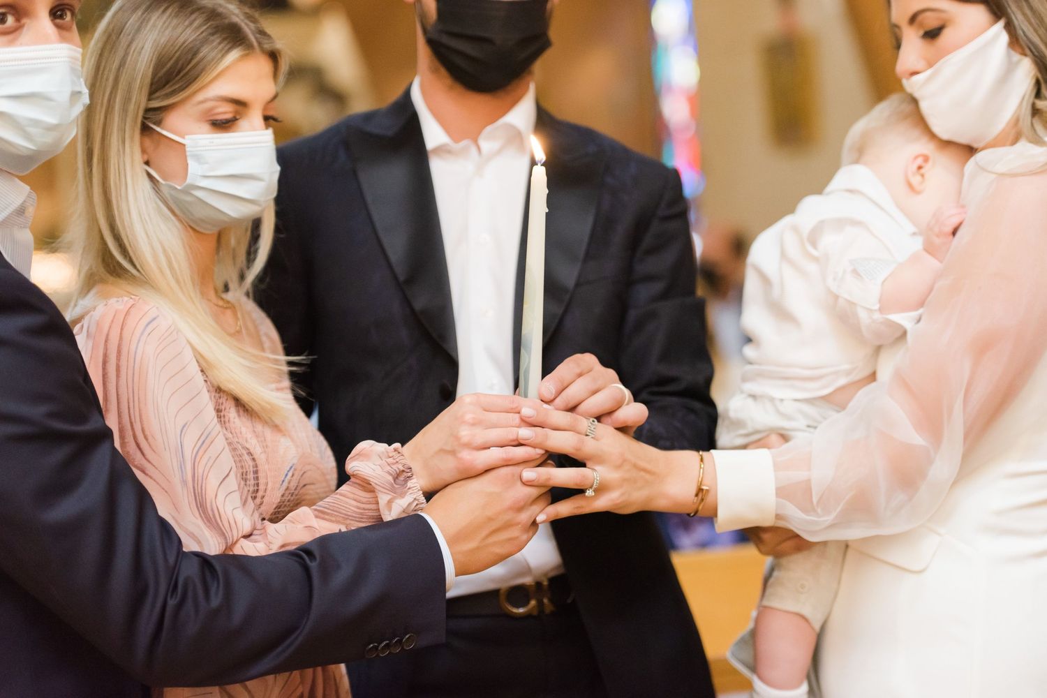 Close-up of hands during religious ceremony in church setting.