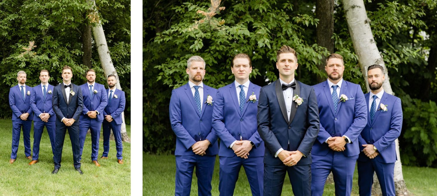 Groomsmen in coordinating navy blue suits pose for formal wedding party photos outdoors.