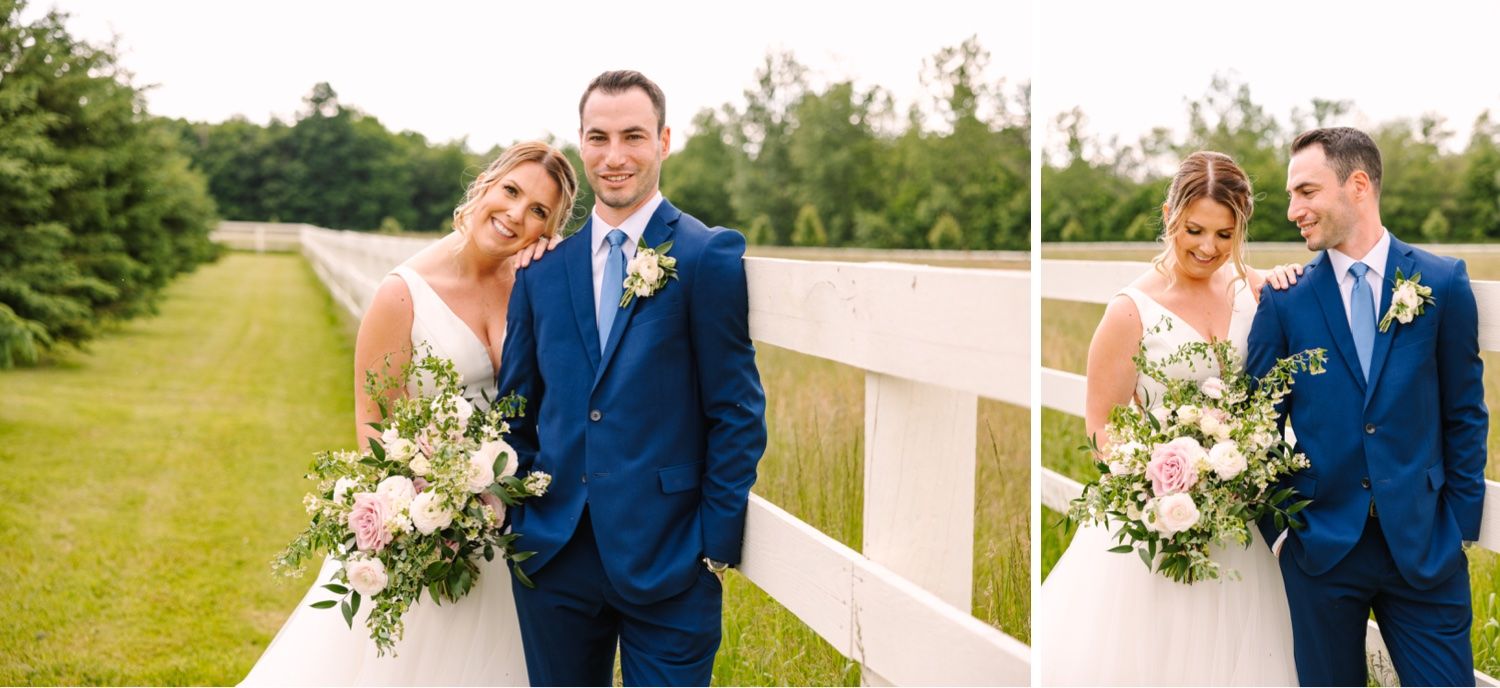 Romantic wedding portraits beside rustic white fence with elegant floral bouquet.