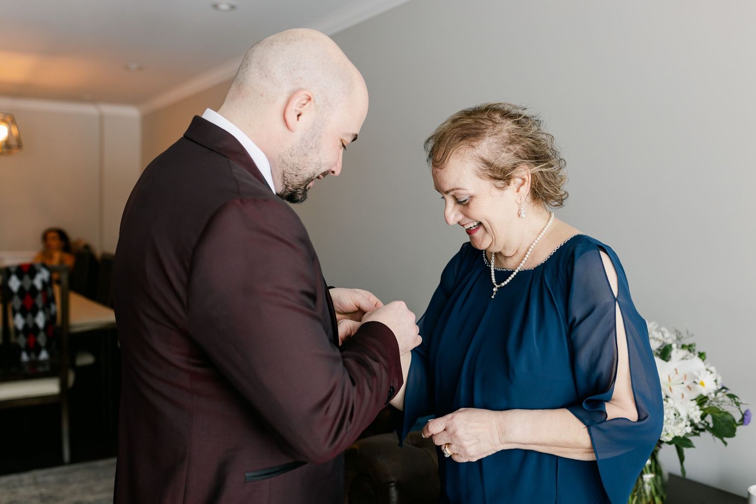 Emotional moment showing corsage pinning at formal event.