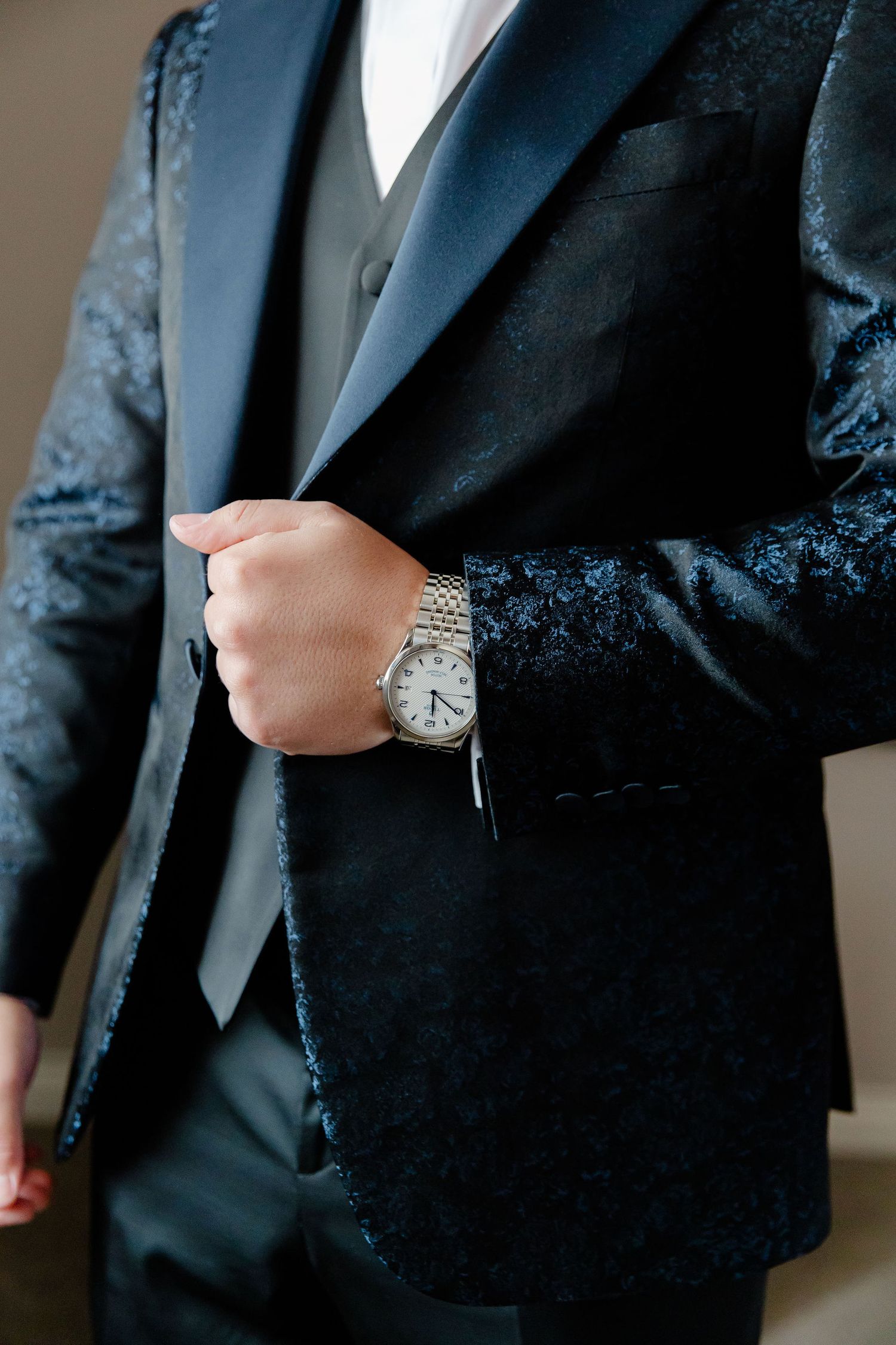 Detail shots of a black formal suit jacket with silver watch visible.