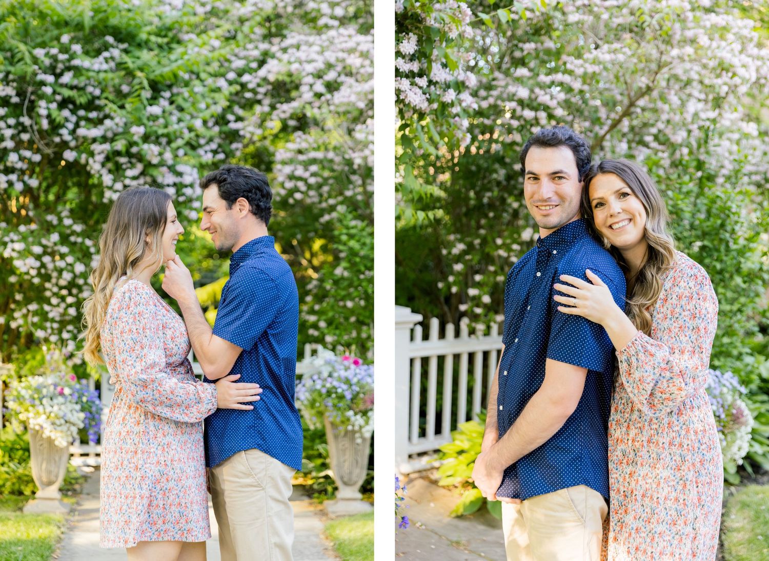 A couple embraces while posing for photos in a garden setting with white flowering bushes.