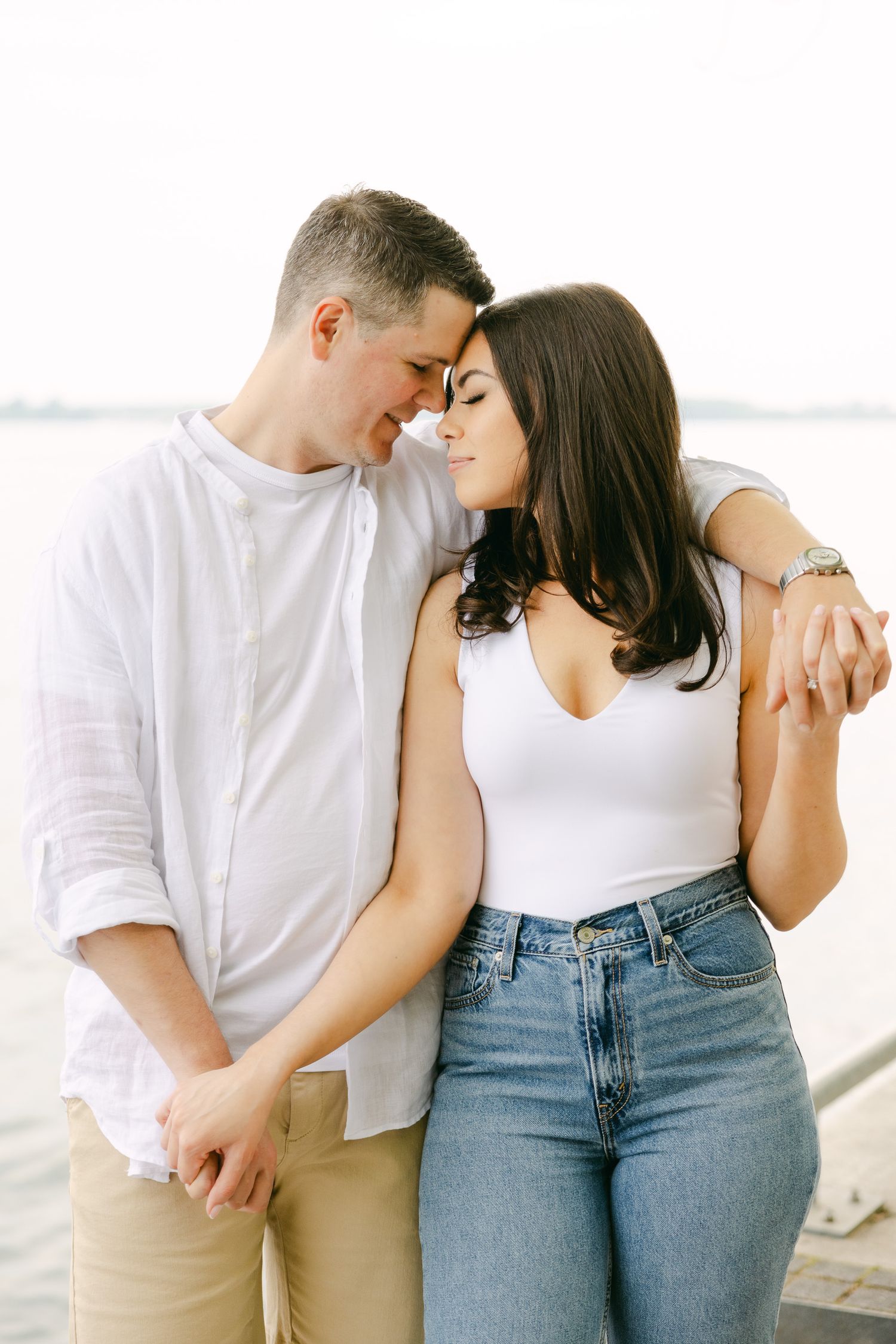 A loving couple in casual spring outfits sharing an intimate moment outdoors.