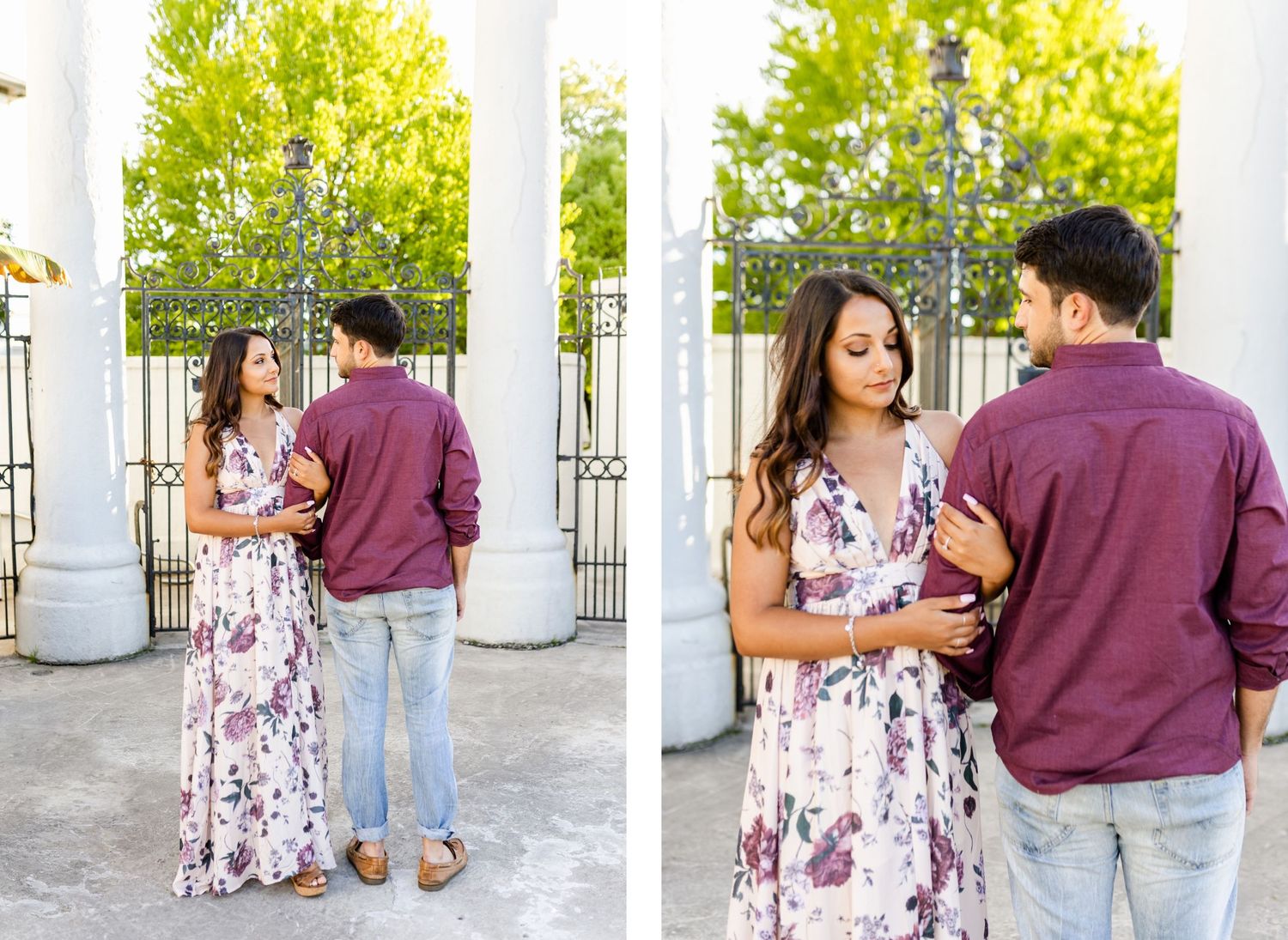 Couple shares intimate moments while posing near white columns with green foliage in background.