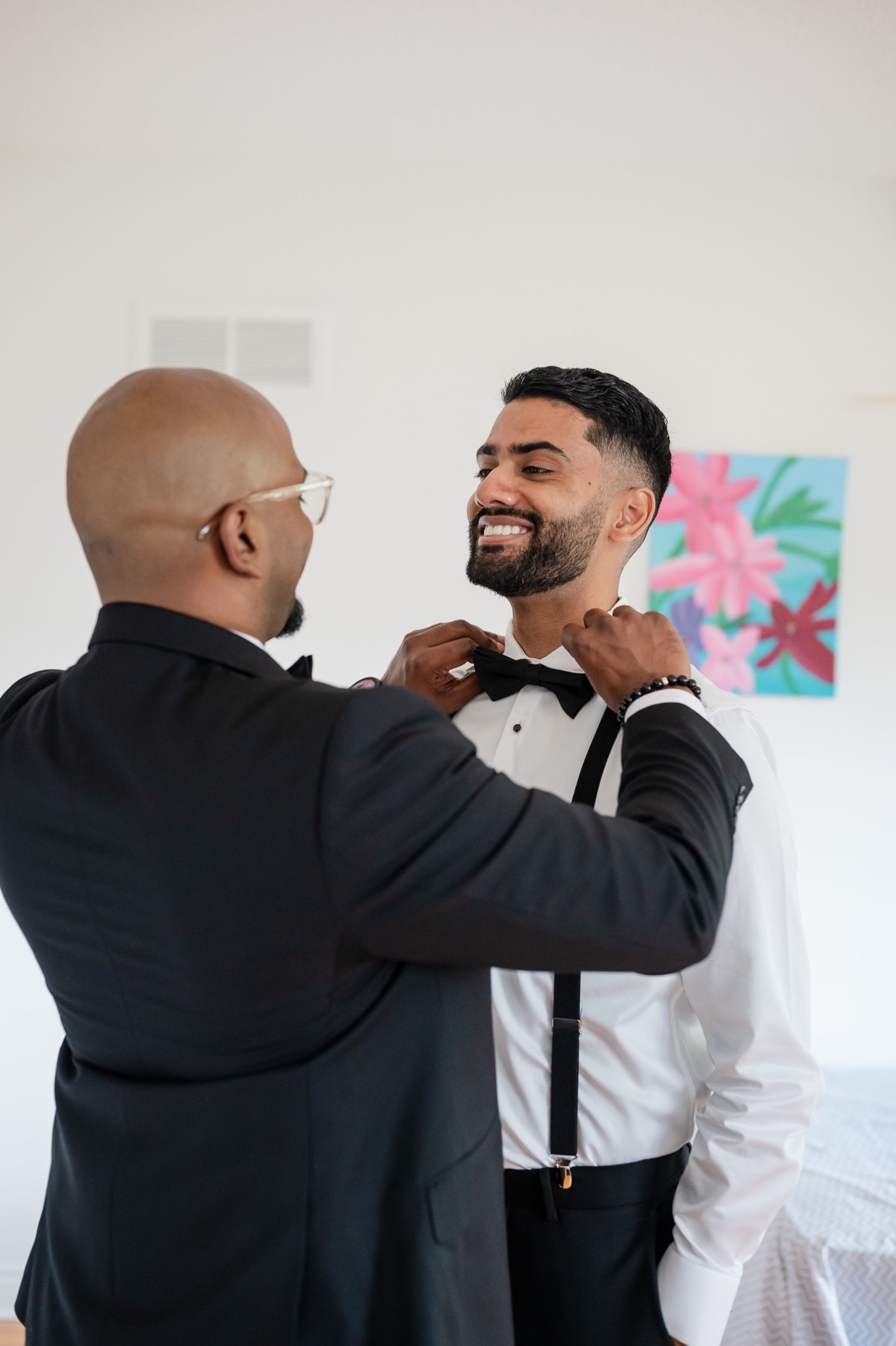 A touching moment between two people during wedding preparation.