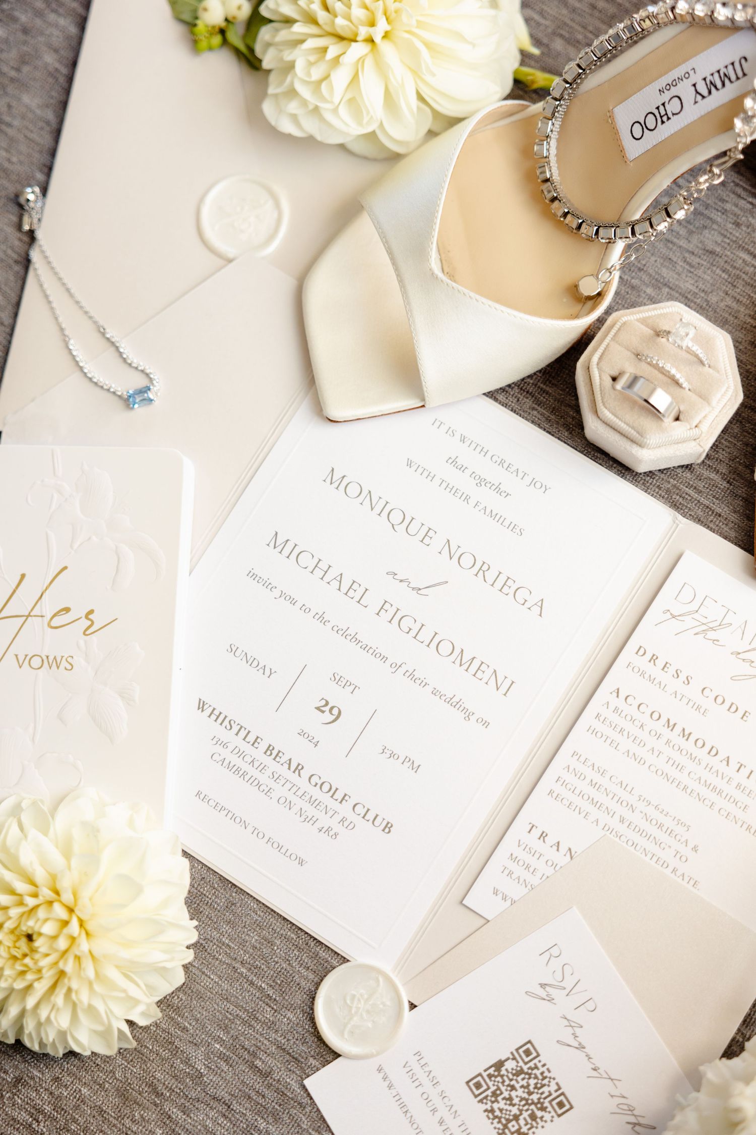 Overhead view of wedding invitations with Jimmy Choo bridal shoes and cream dahlias.
