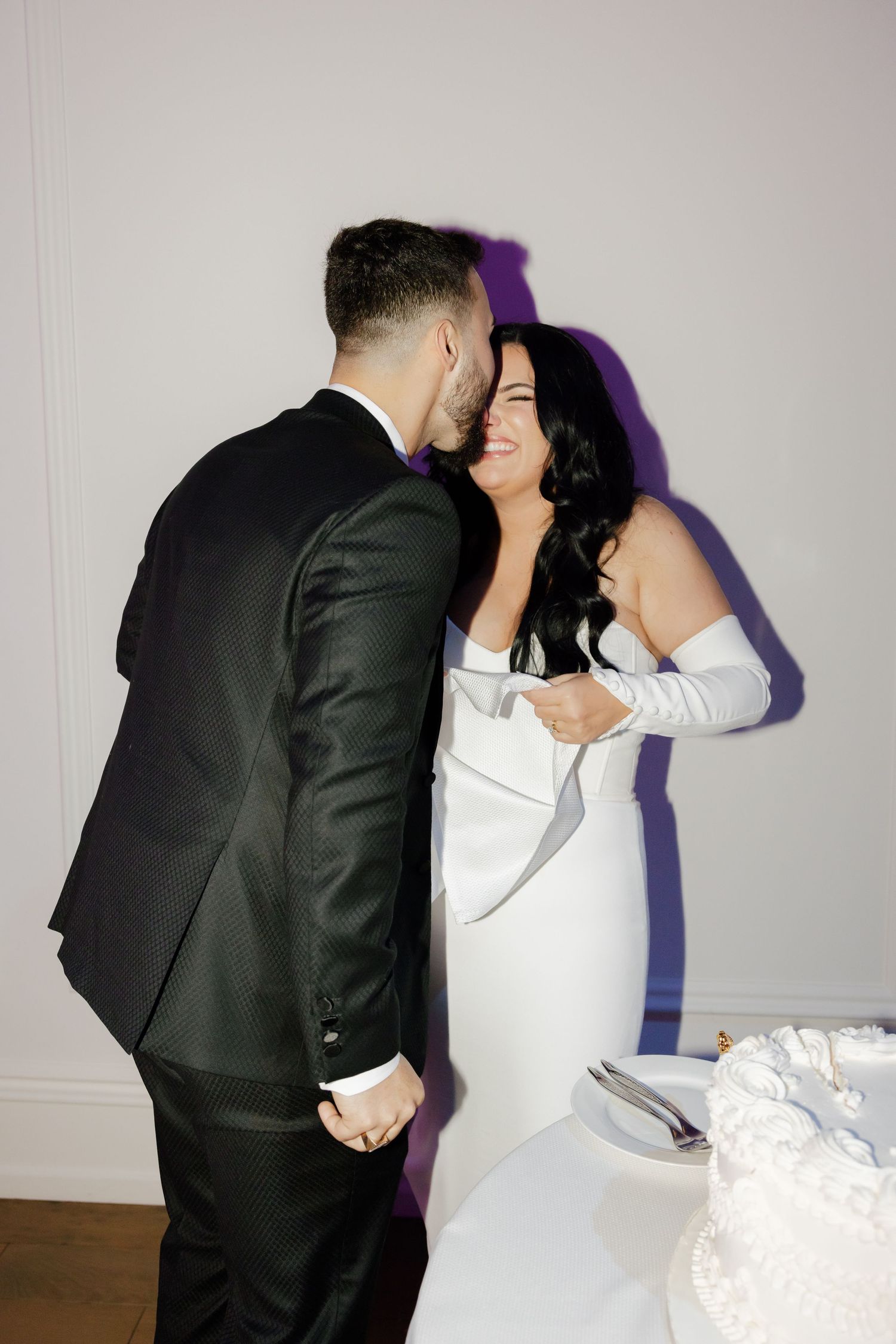 Intimate candid moment between newlyweds during their wedding reception.