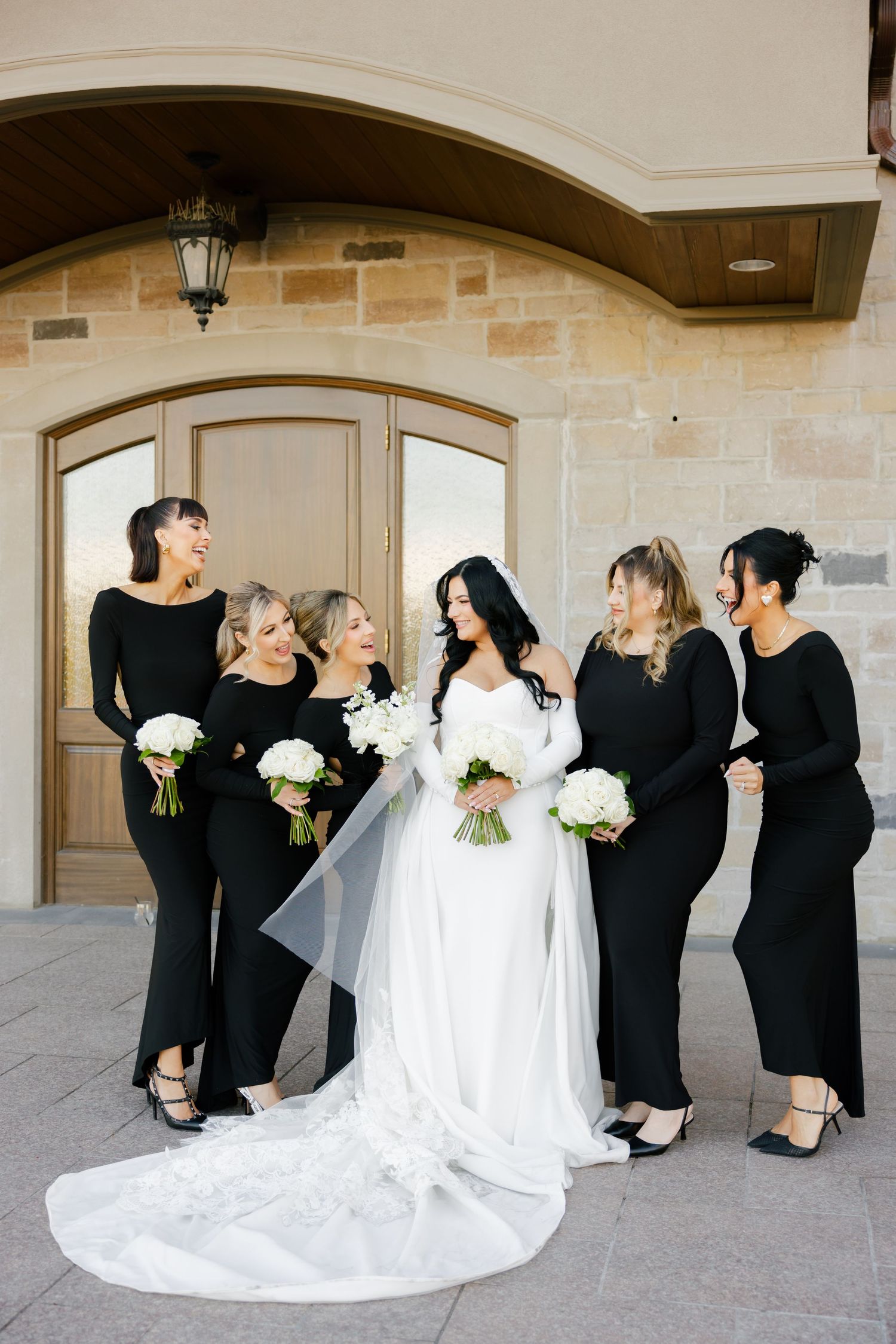 Candid moment of bridal party sharing laughter during wedding photo session.