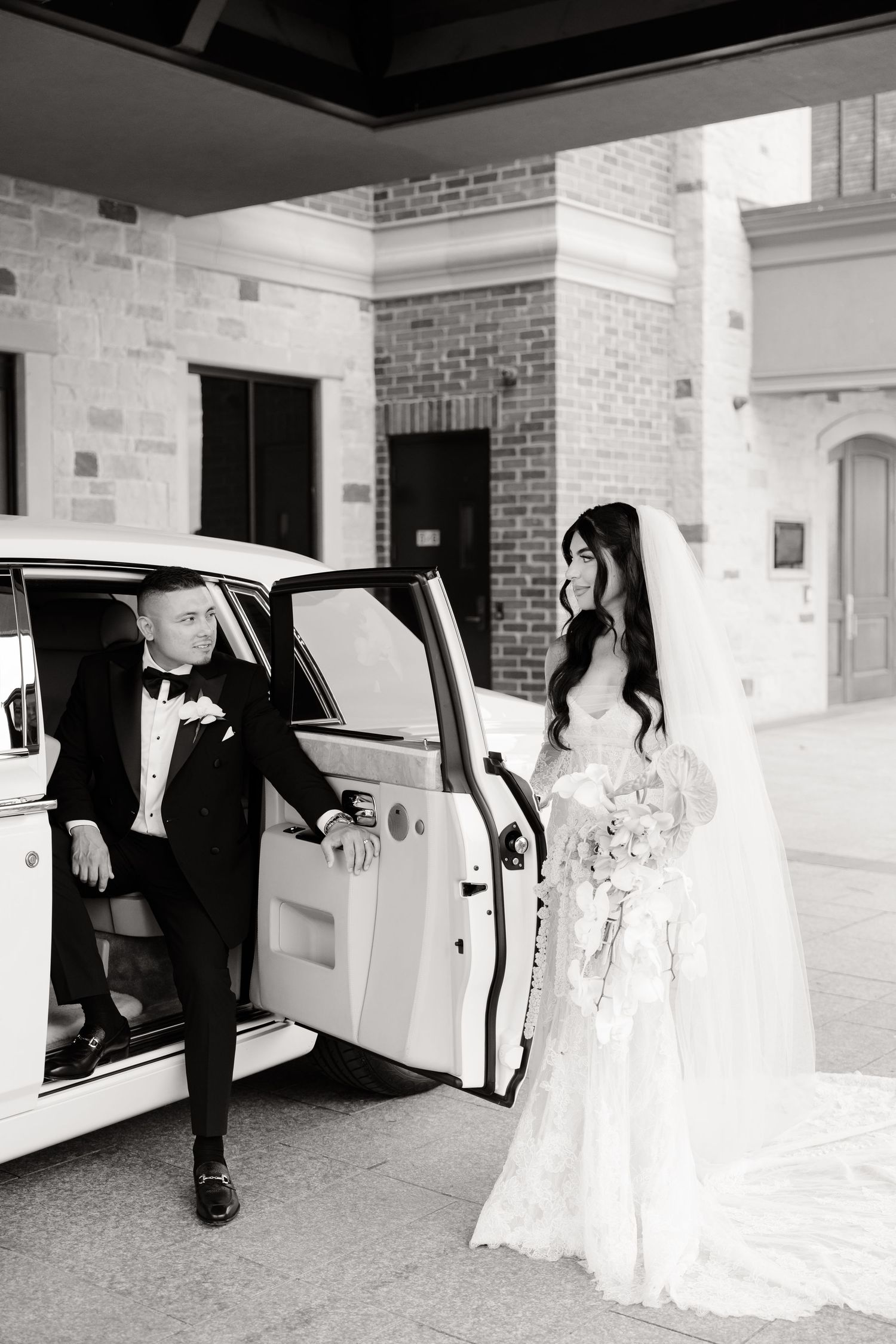 A sequence of black and white wedding photos showing a couple entering a car after their ceremony at a brick venue.