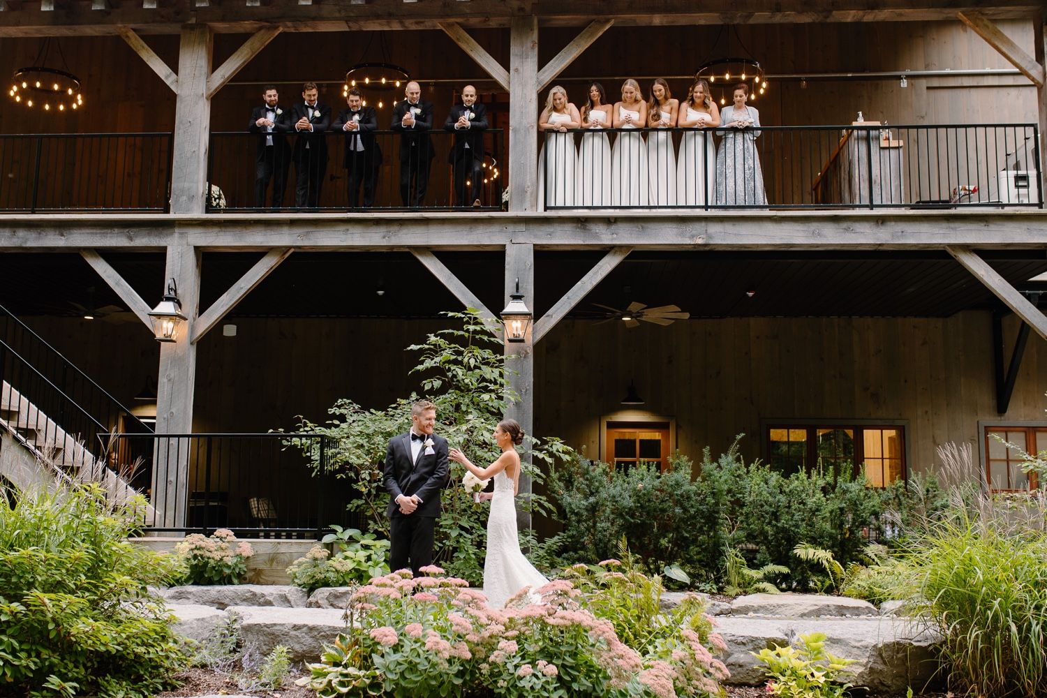 Scenic wedding ceremony site with wooden pavilion and landscaped gardens.