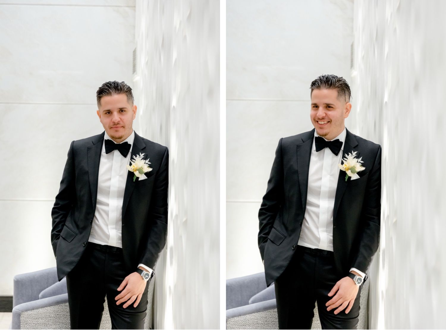 A groom in a classic black tuxedo and bowtie poses against a white wall.