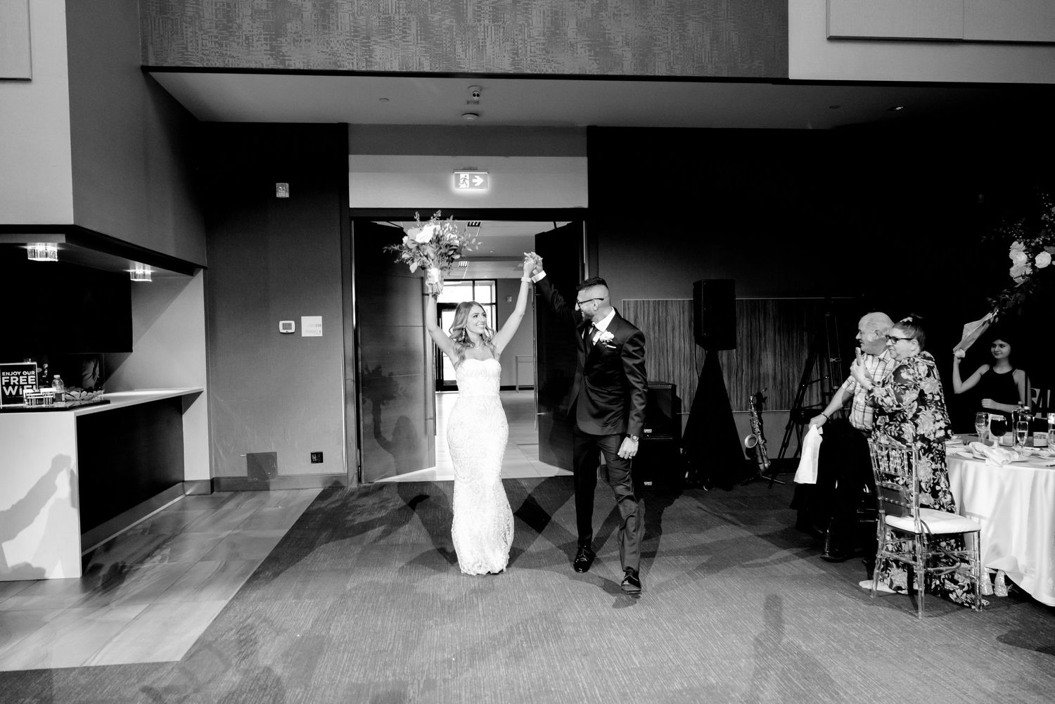 Newlyweds make their grand entrance into the modern reception venue.