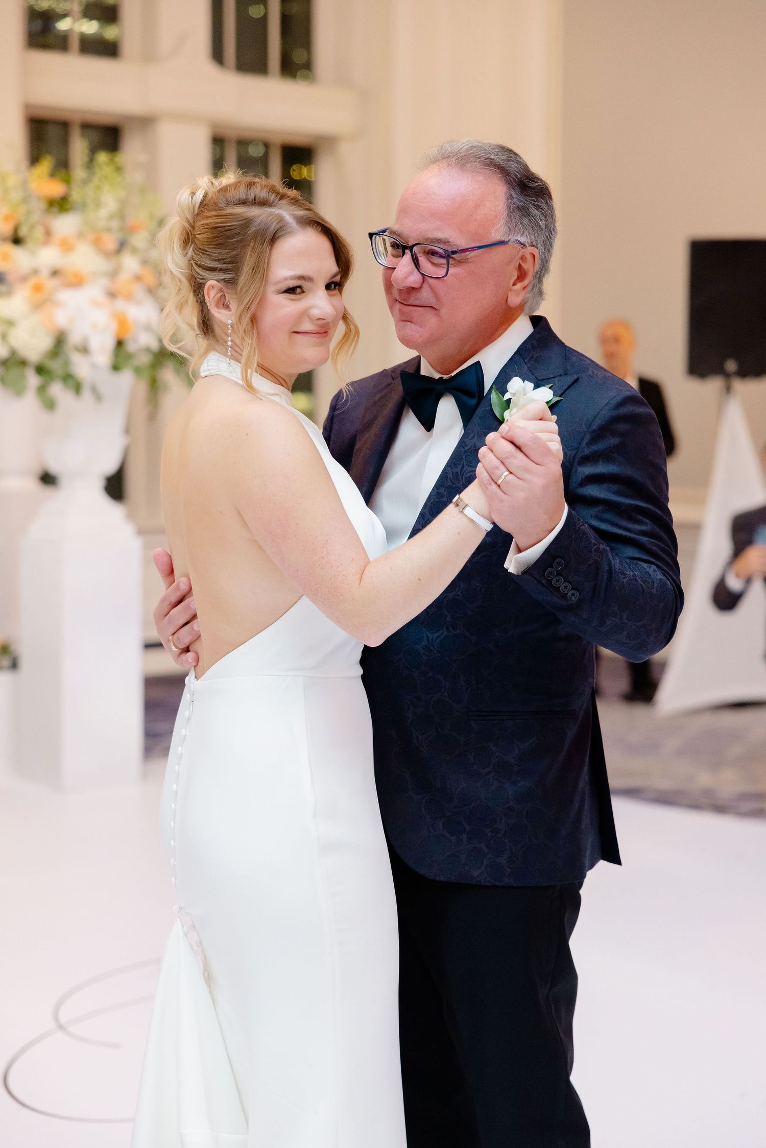 Wedding couple sharing a romantic dance moment in a beautifully decorated reception venue.