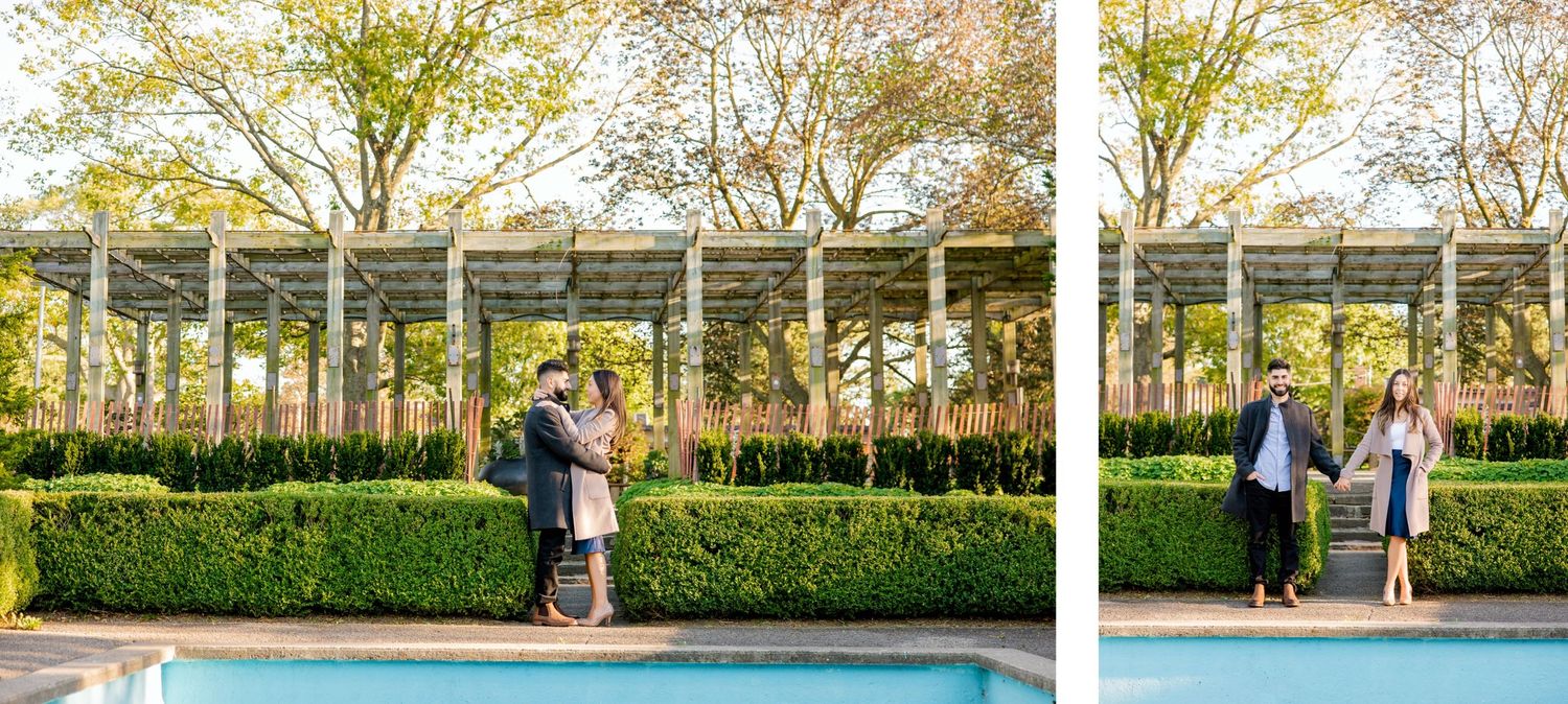 Couple sharing romantic moments under a pergola in a manicured garden.