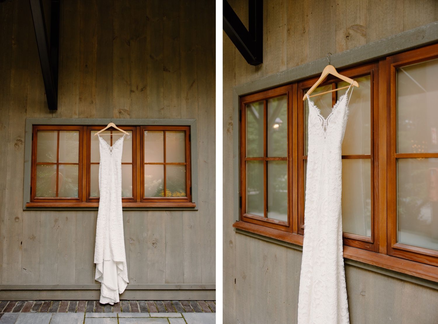 Elegant white wedding dress hanging in front of wooden framed windows.