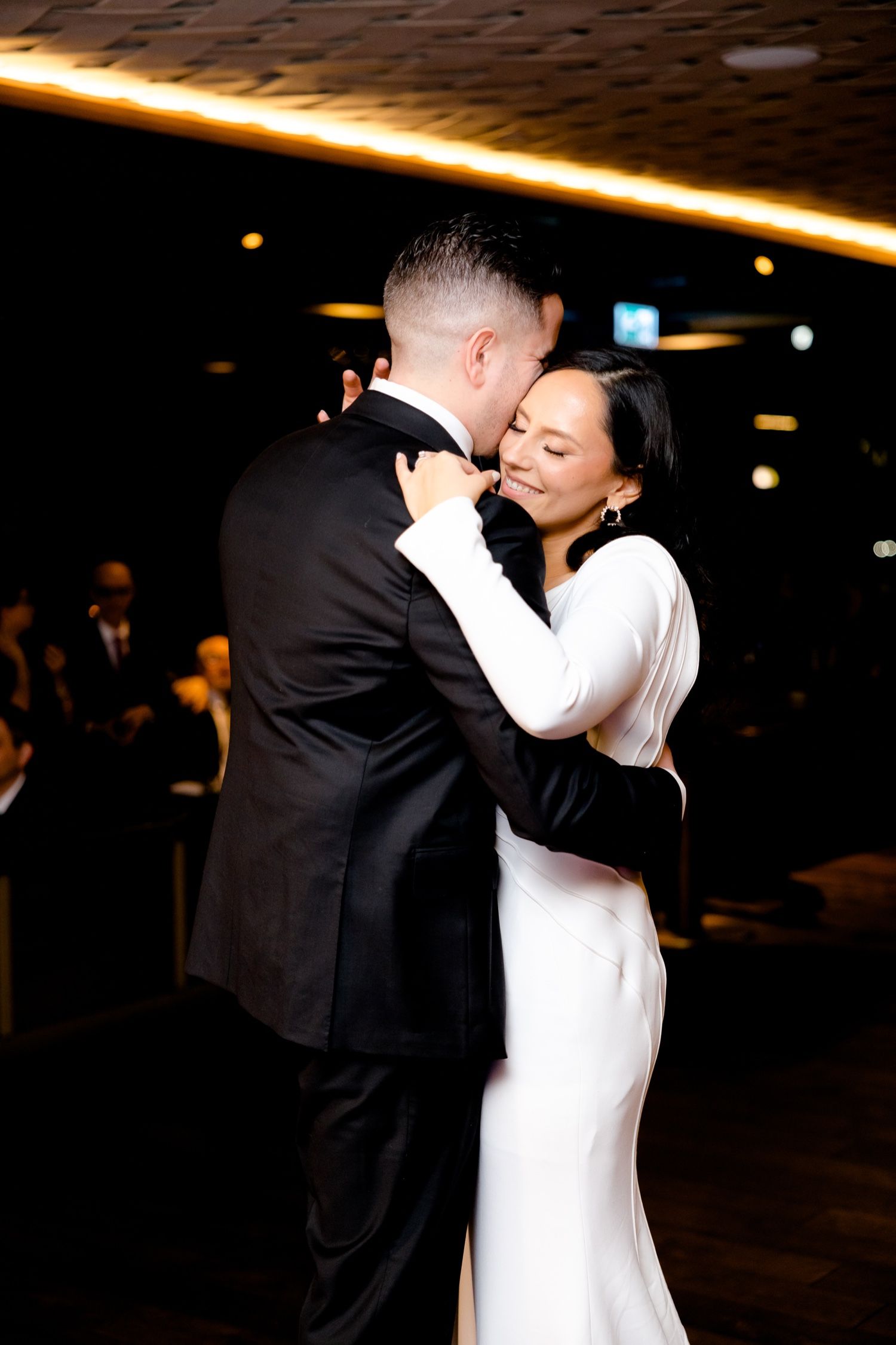Intimate dance moment under warm lighting in an upscale venue.